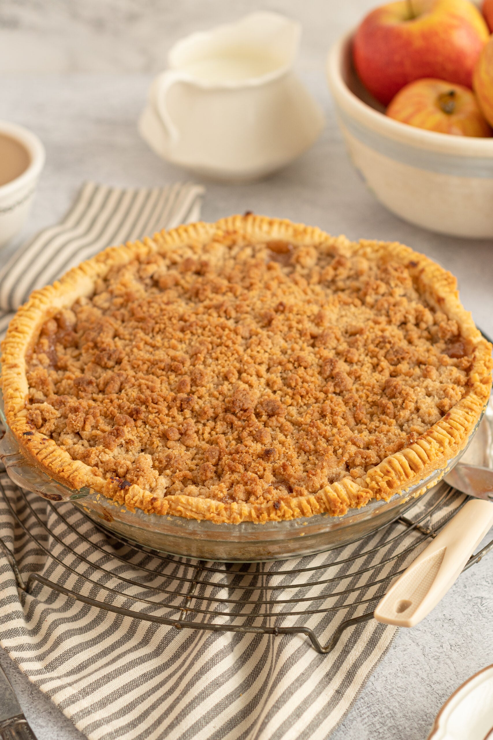 a photo of the Dutch apple pie unsliced in a glass pie dish 