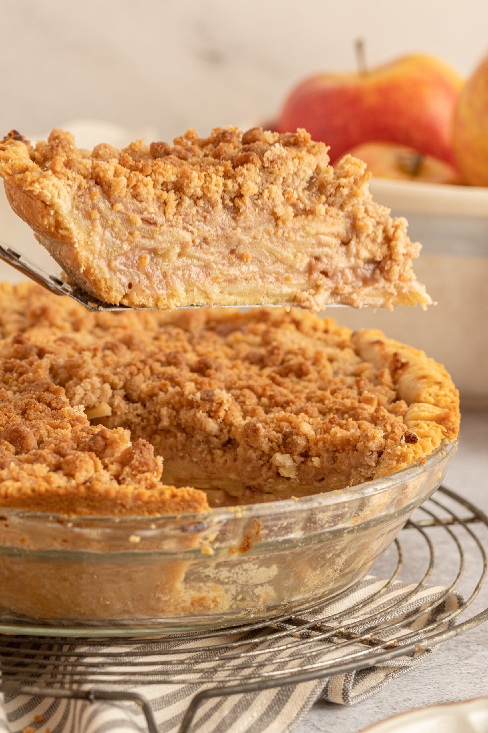 Dutch apple Pie slice being lifted on a silver spatula 
