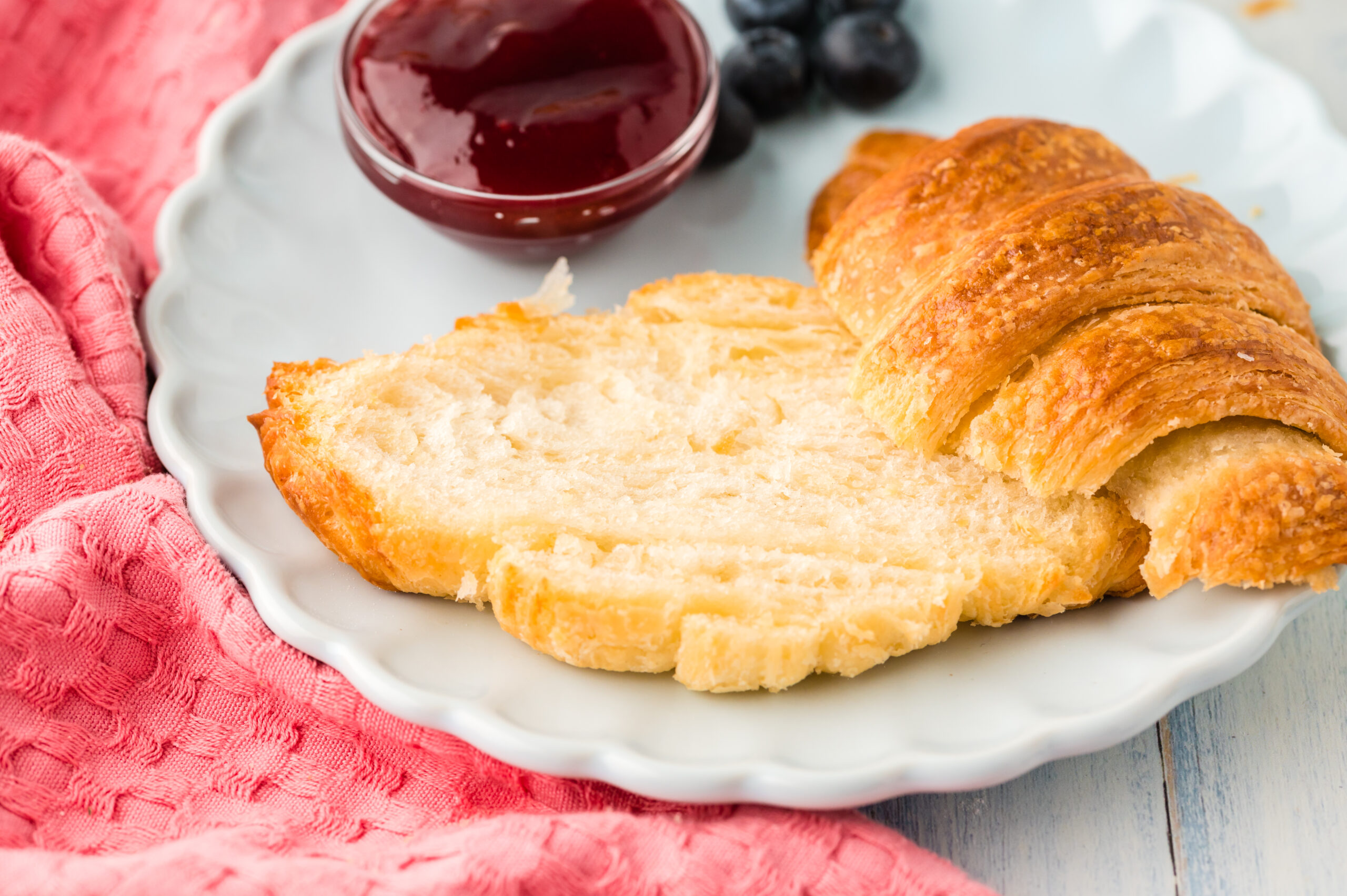 Croissants on a plate cut open to show the inside
