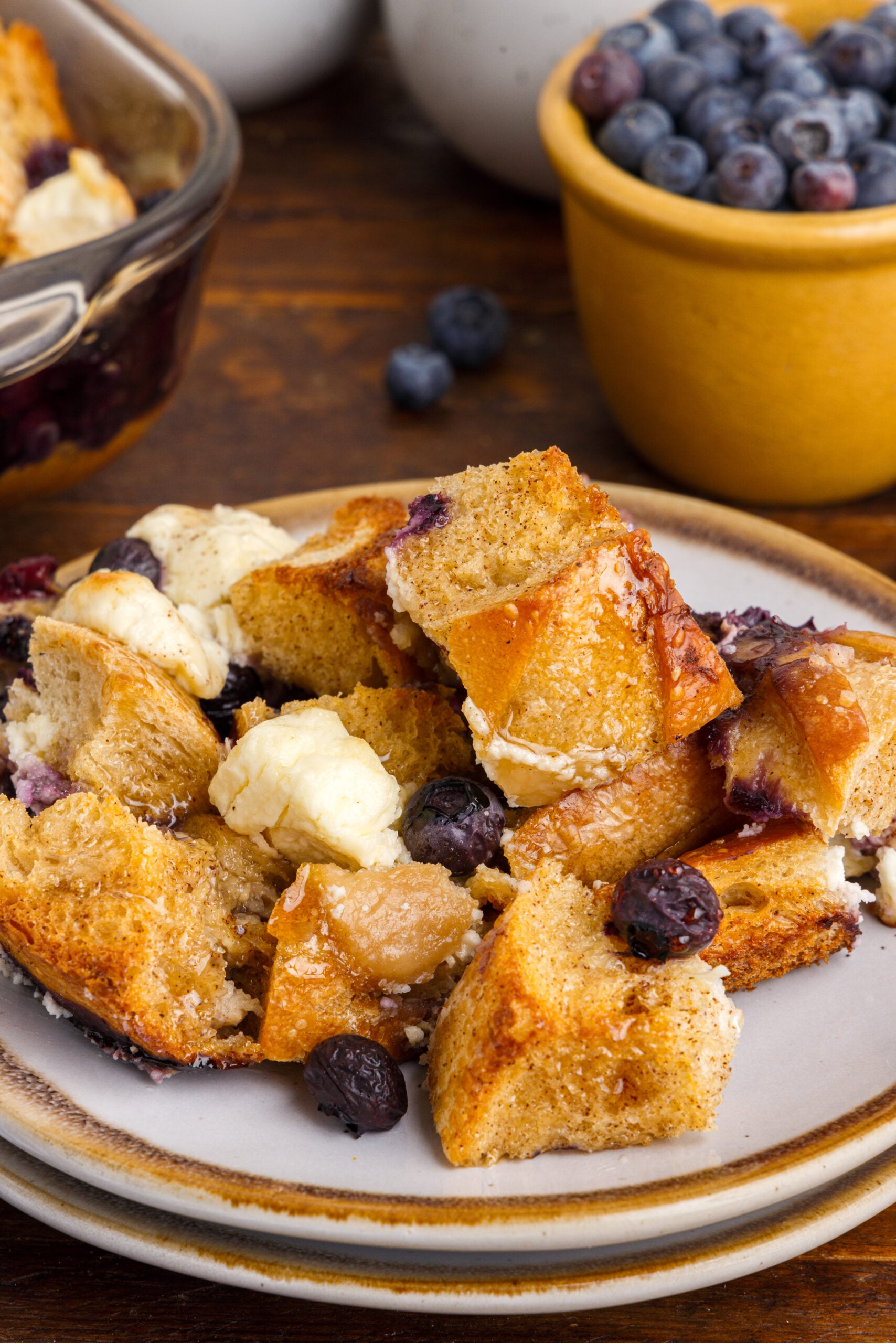 Blueberry French Toast Casserole on a plate topped with syrup