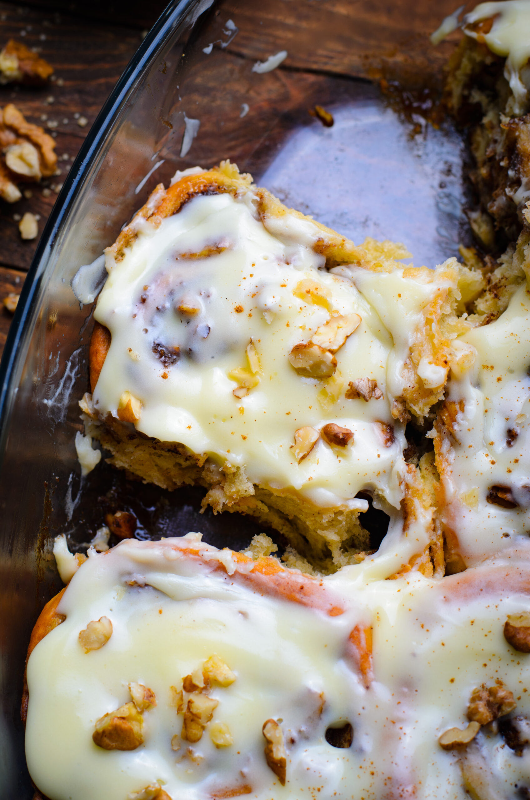 Close up view of a Banana Nut Cinnamon Roll in a clear baking dish.
