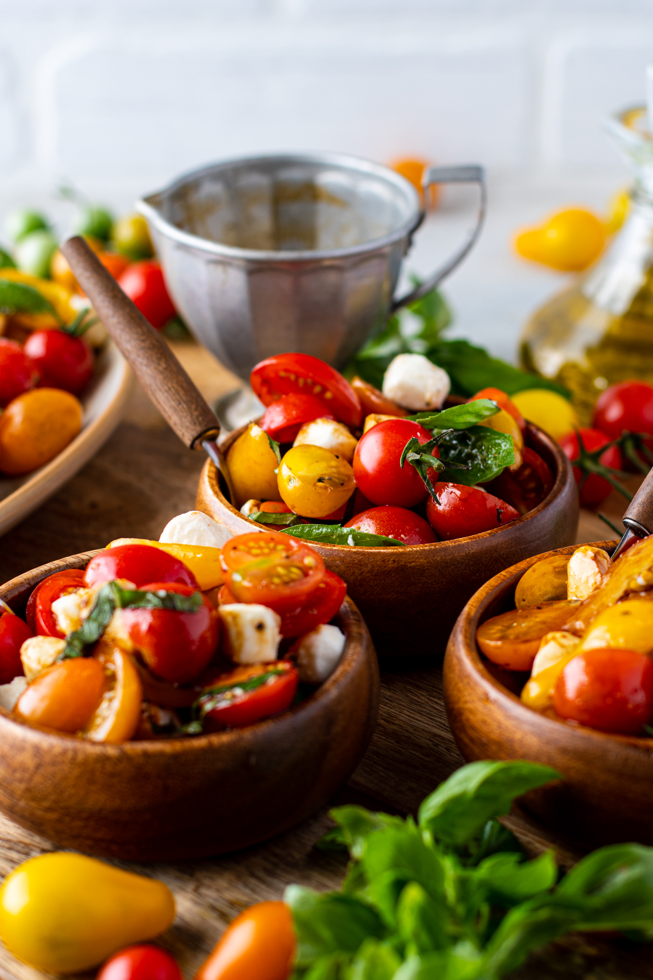 3 small wooden bowls of the caprese salad