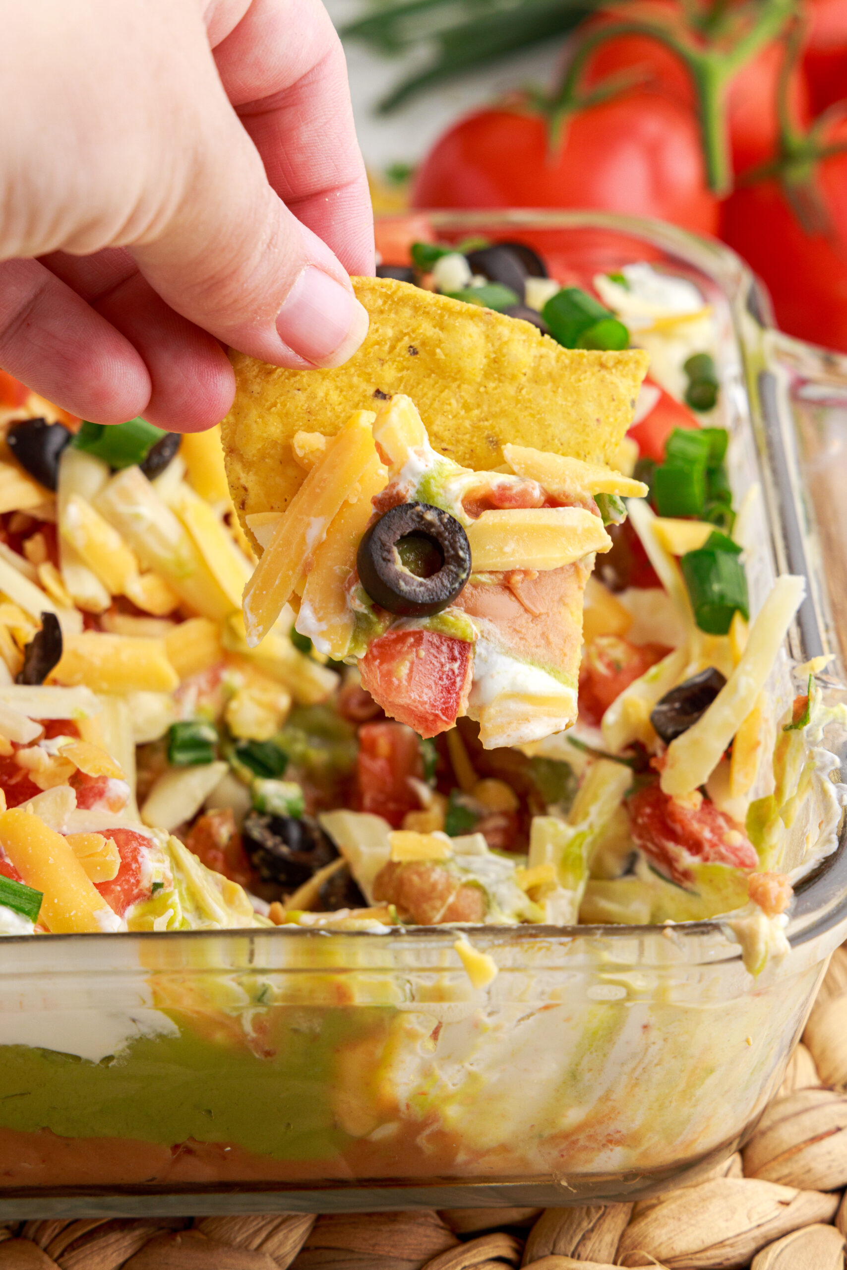 Close up view of a chip dipped in 7-Layer Dip.