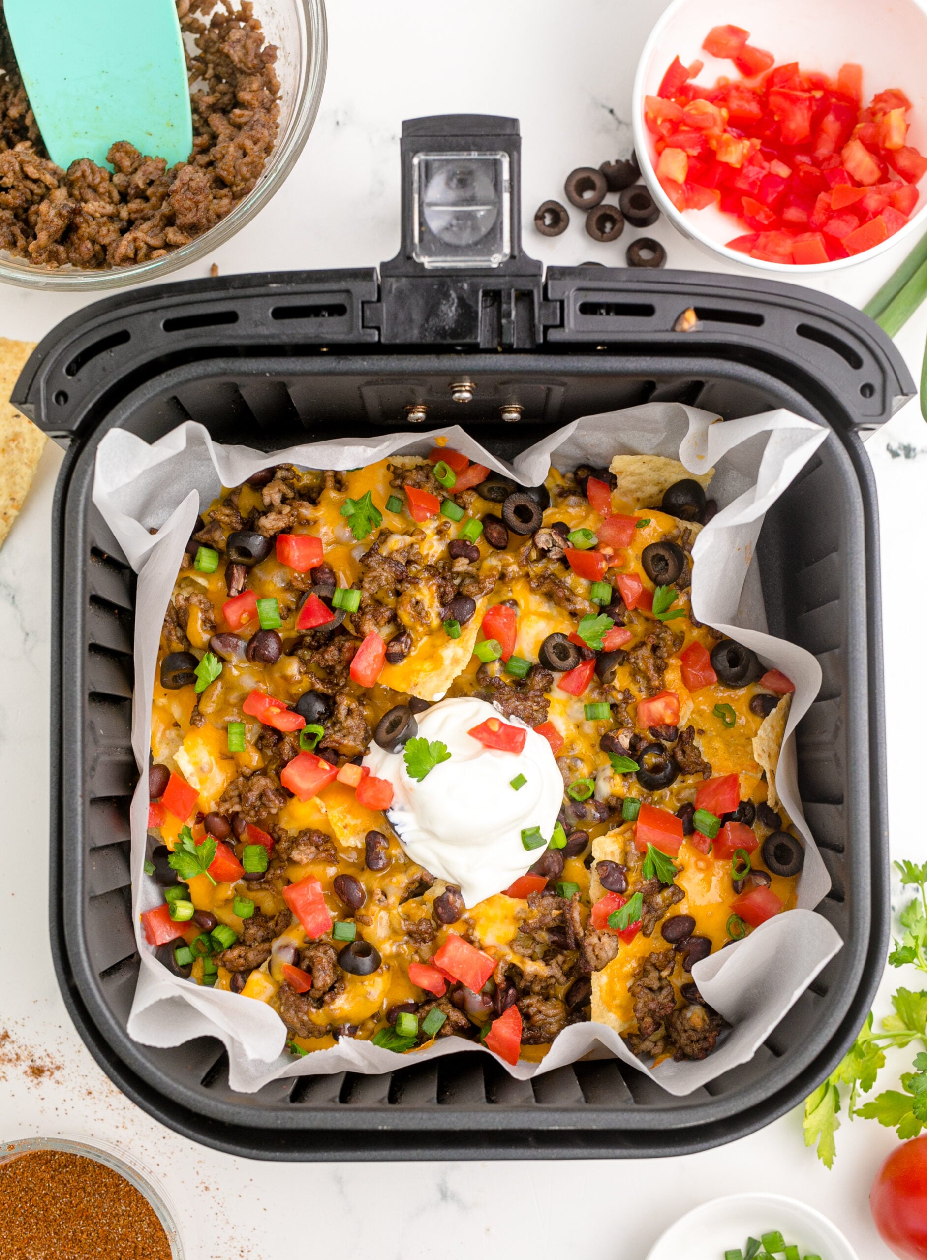 Overhead view of Air Fryer Nachos in an air fryer basket.