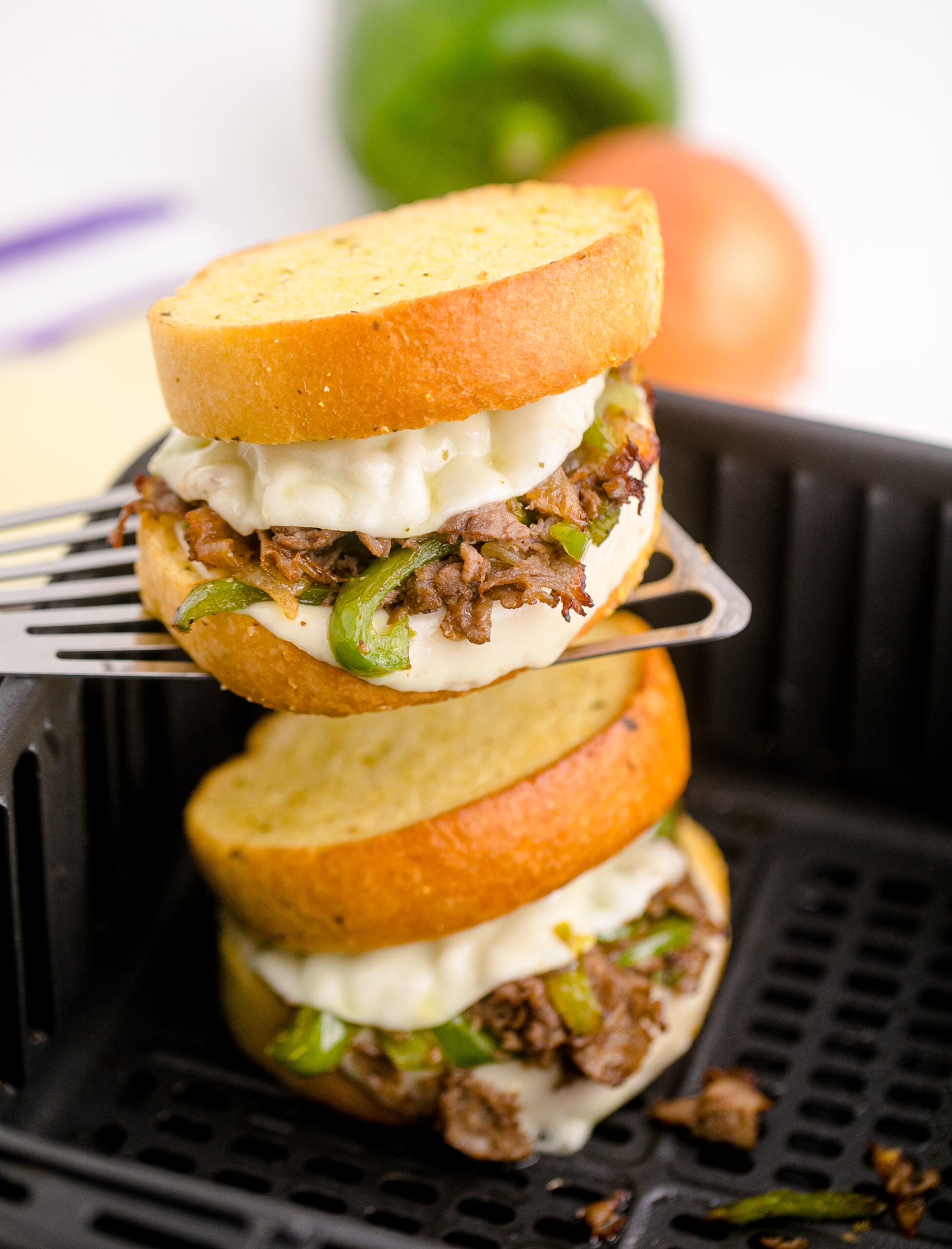 Front view of Air Fryer Philly Cheese Steaks On a silver spatula.
