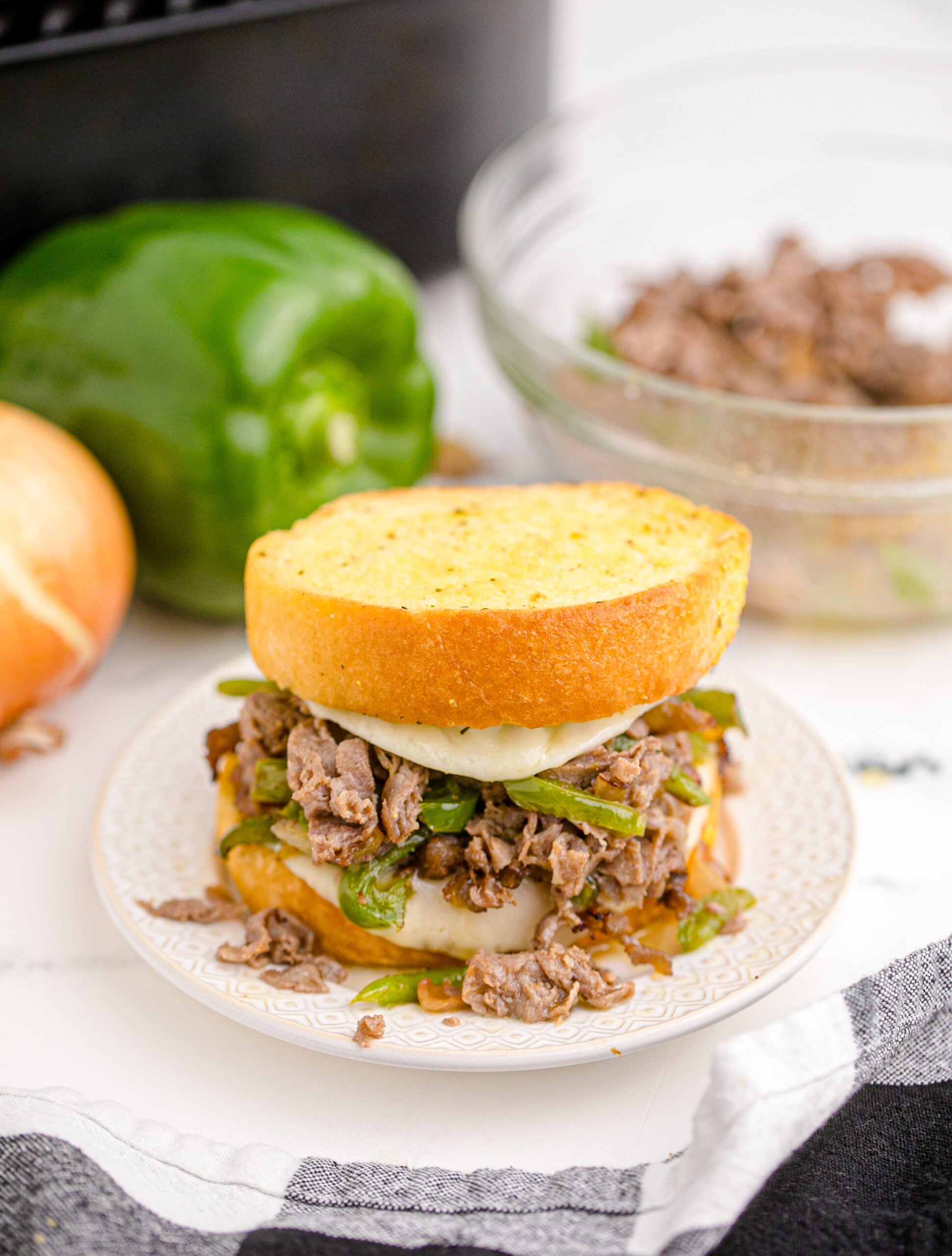 Front view of Air Fryer Philly Cheese Steaks on a white plate.