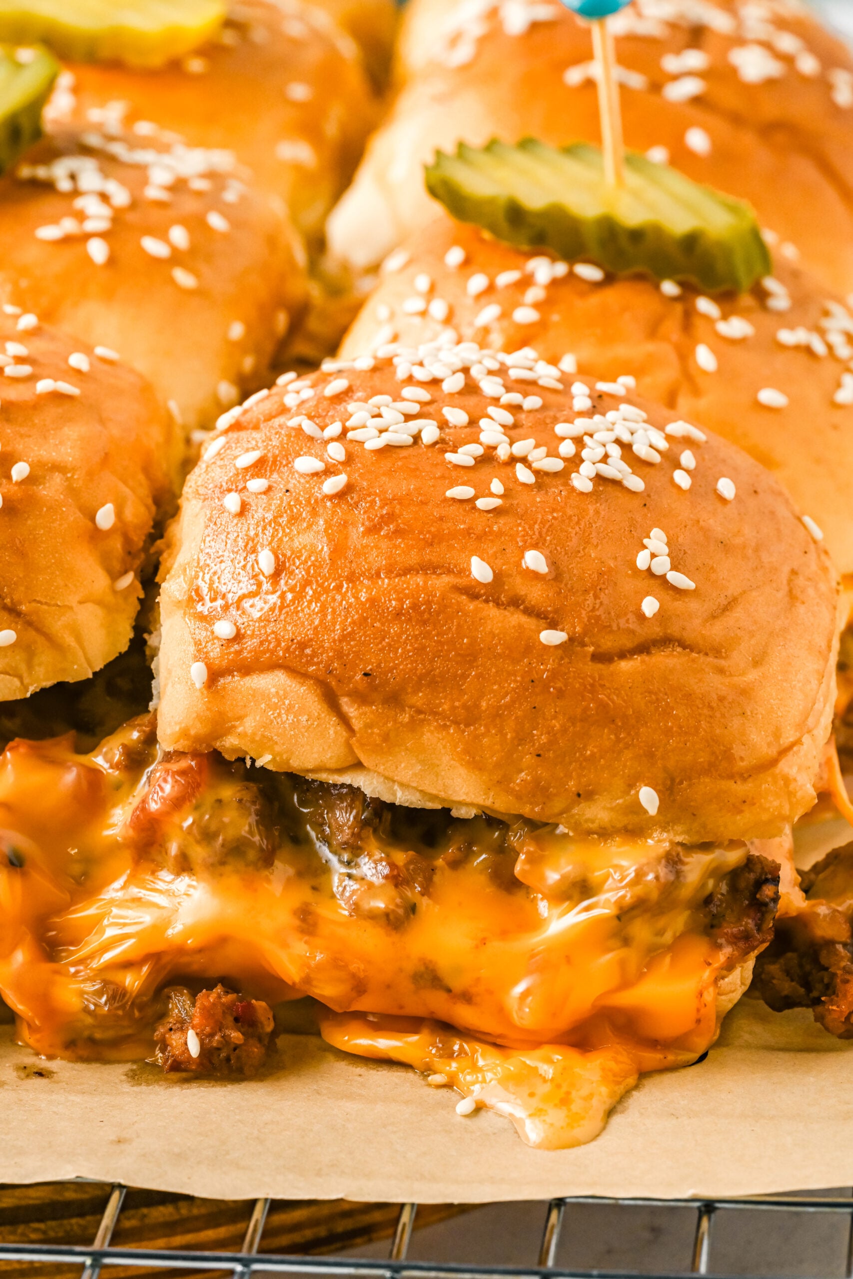 Up close view of Cheeseburger Sliders on a wire rack.