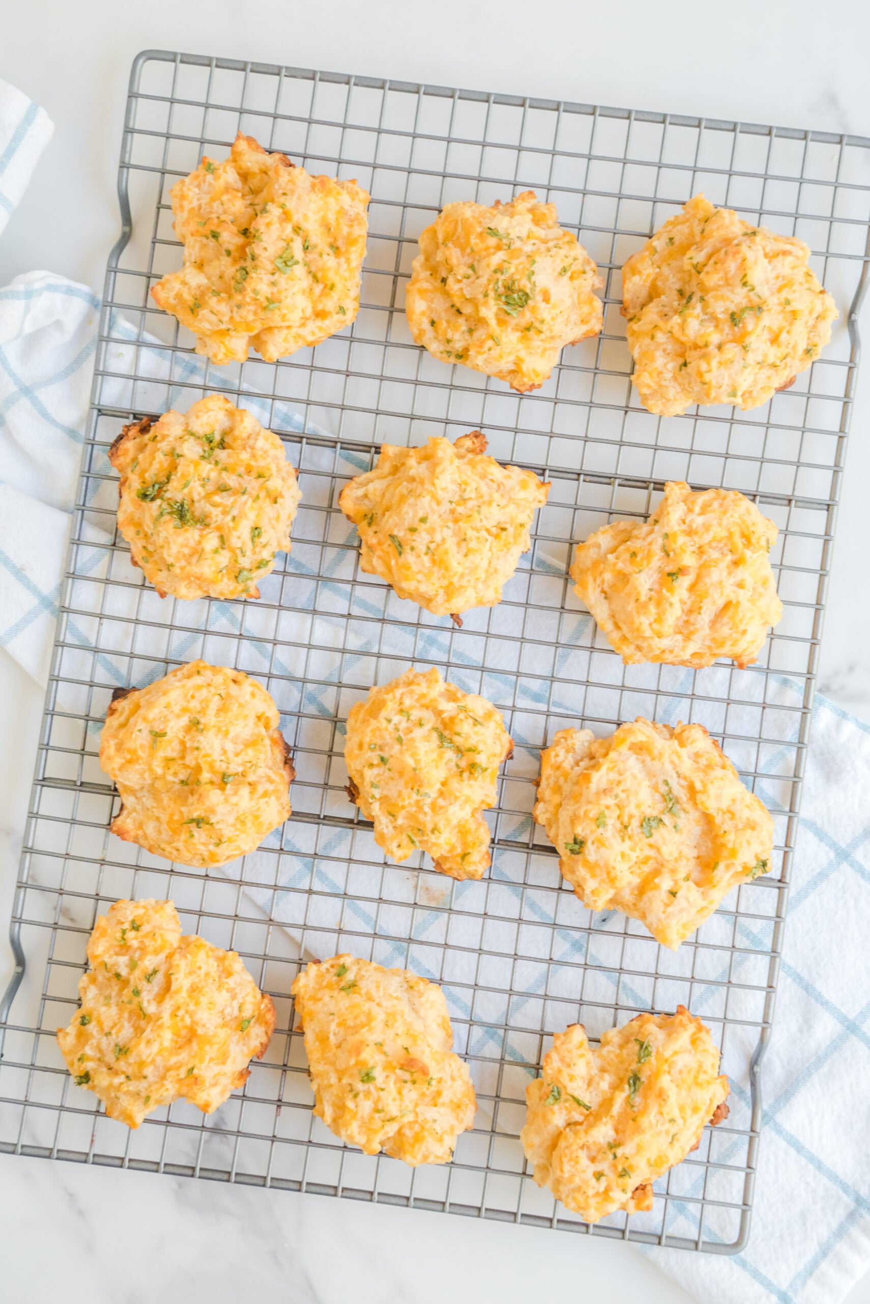Overhead view of Copycat Red Lobster Cheddar Bay Biscuits on a wire rack.
