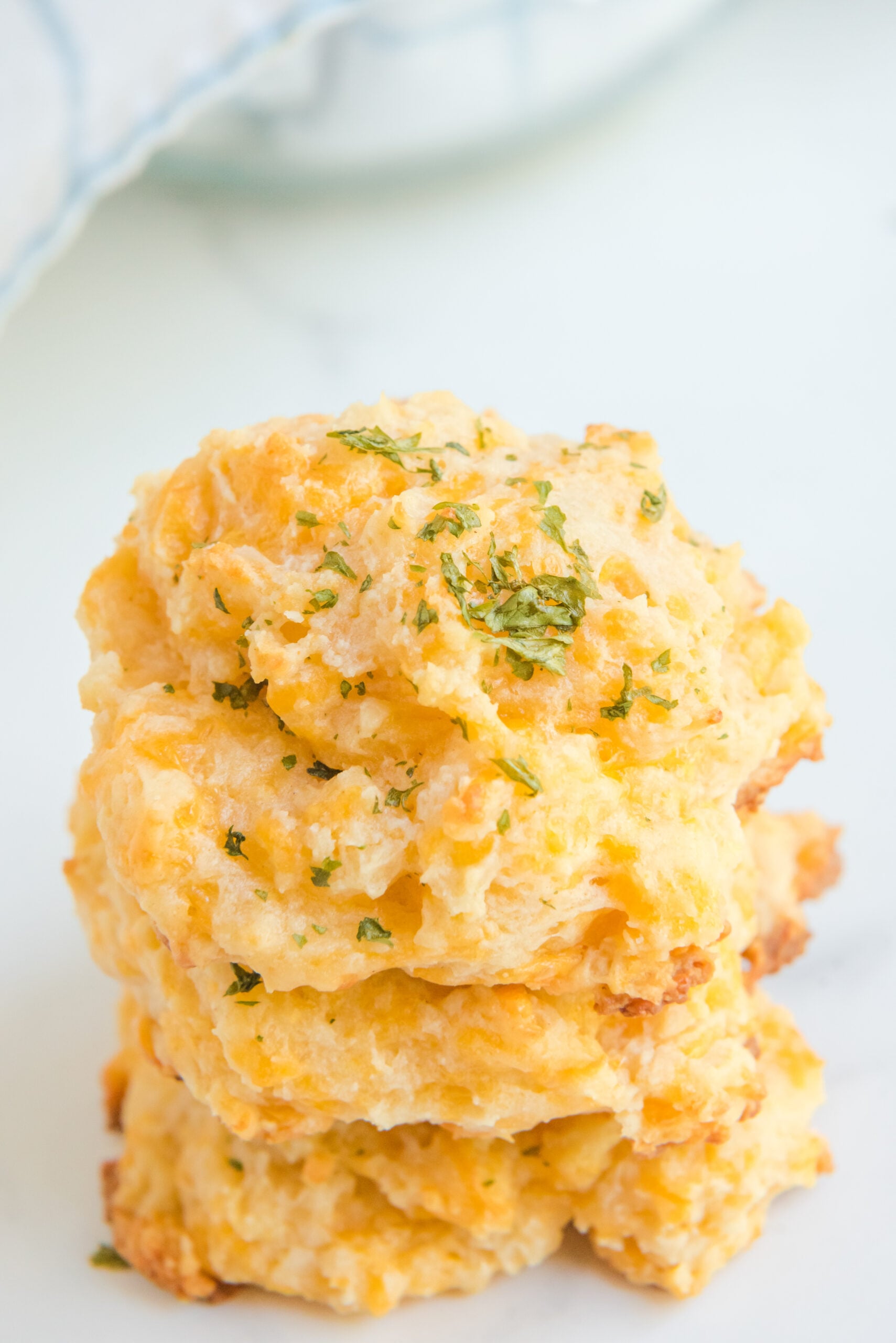 Side view of three Copycat Red Lobster Cheddar Bay Biscuits stacked,