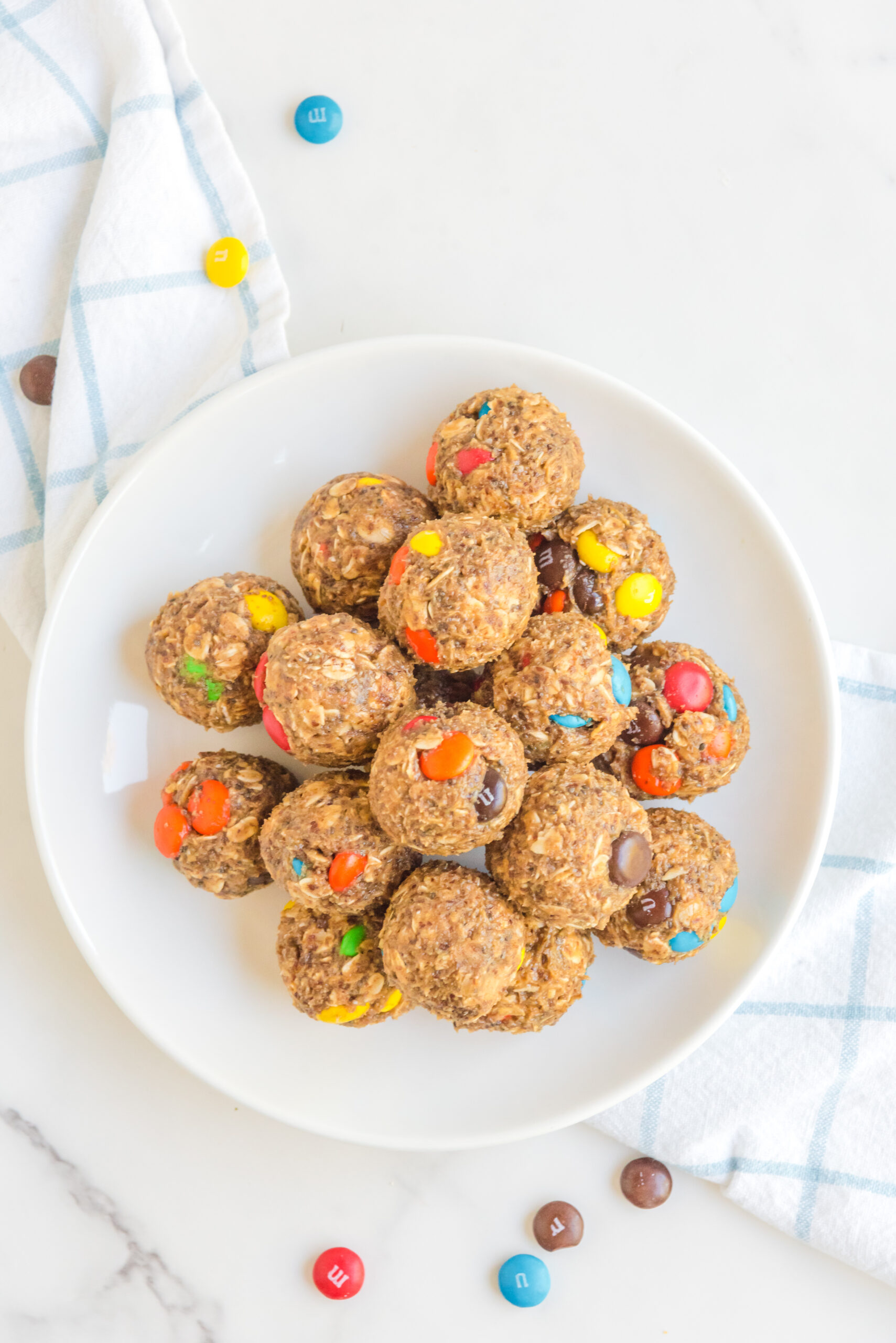Overhead view of No Bake M&M Energy Balls in a white dish.