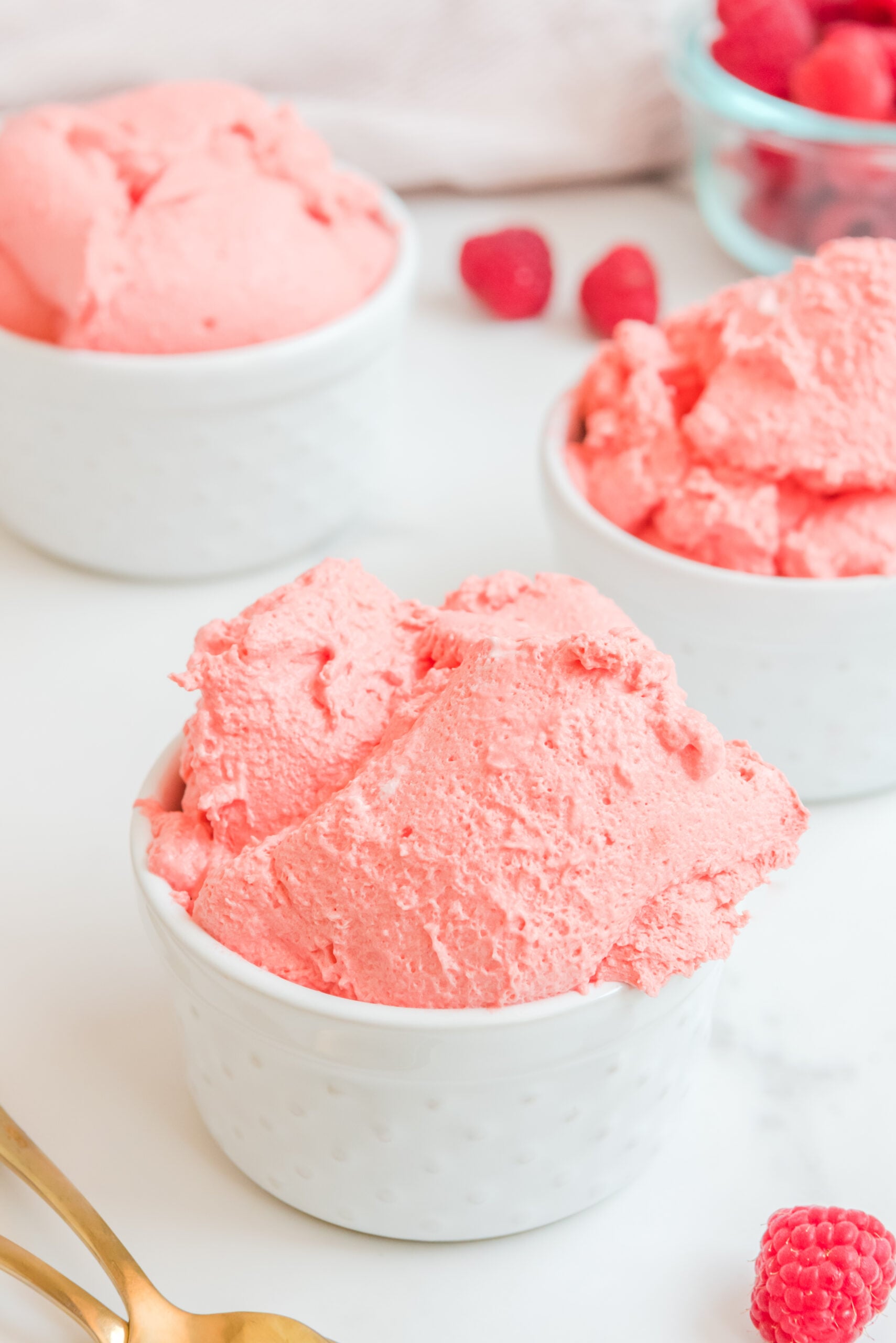 Front view of Raspberry Jello Fluff in a white dish.