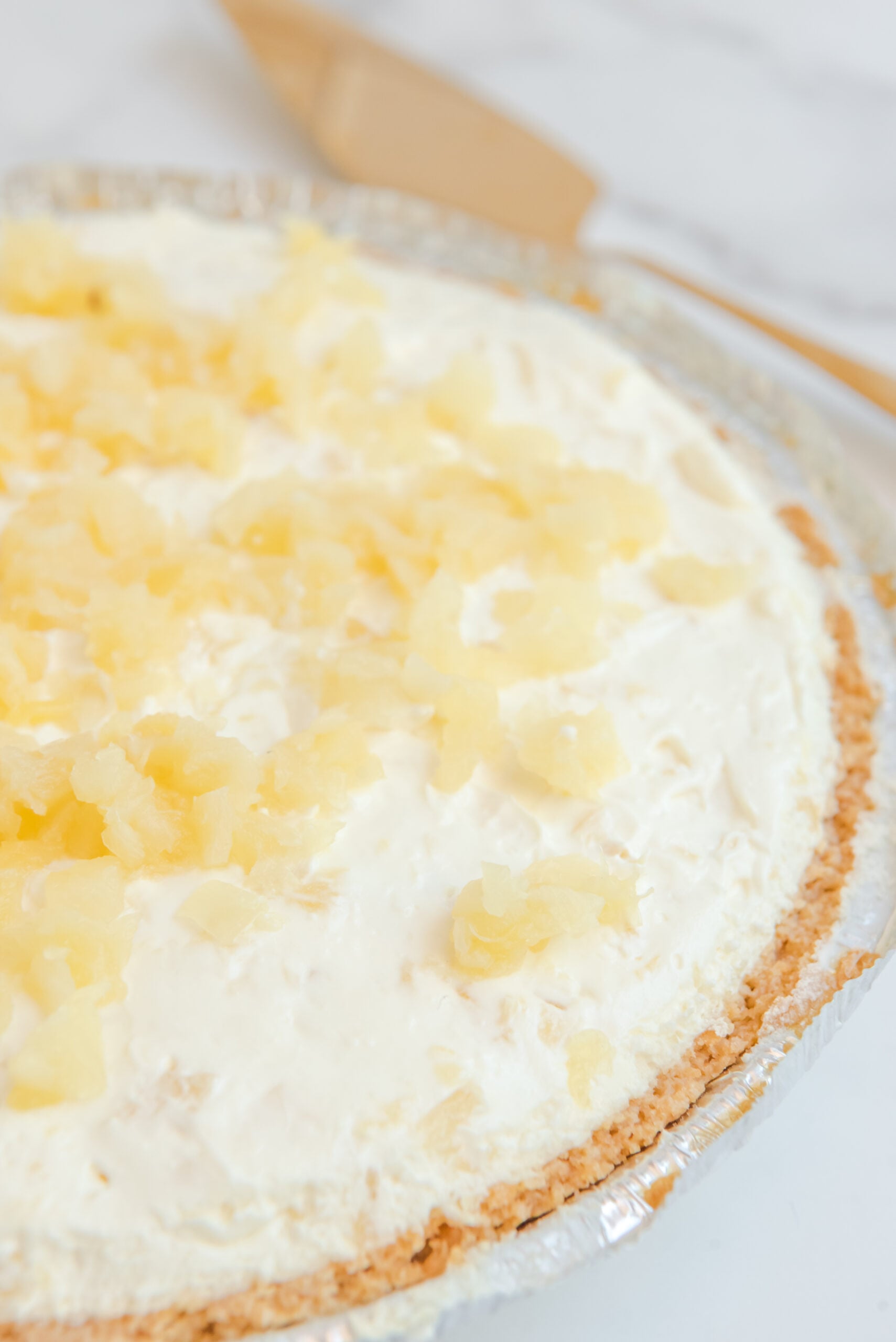 Close up view of No Bake Pineapple Cheesecake uncut.