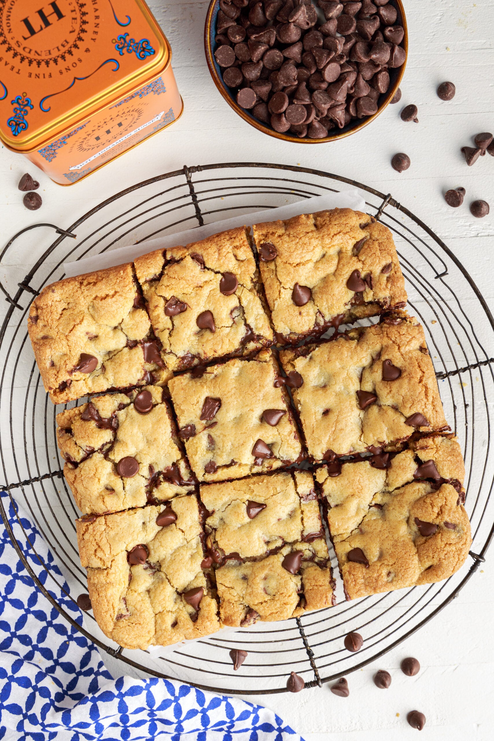 Overhead view of Gooey Chocolate Chip Cookie bars cut into nine squares on a wire rack 