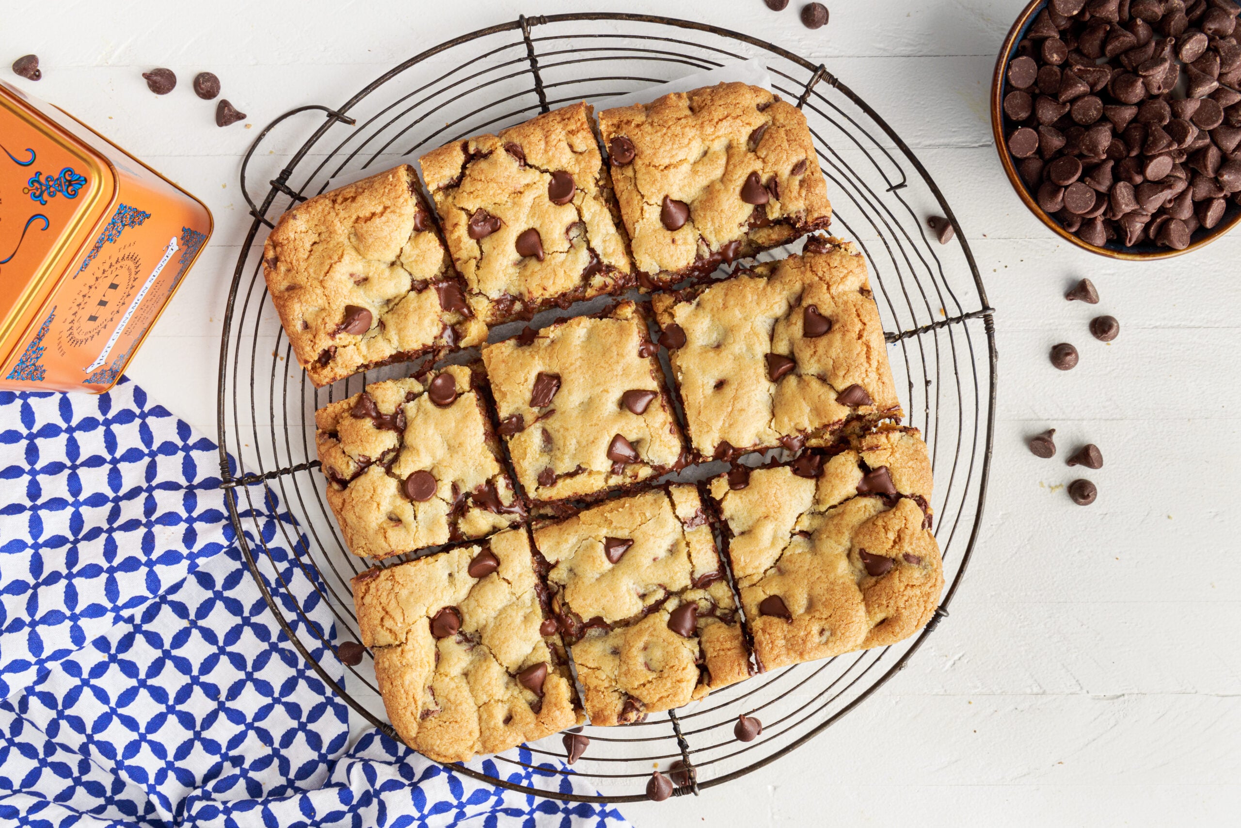 Overhead view of Gooey Chocolate Chip Cookie bars cut into nine squares on a wire rack 