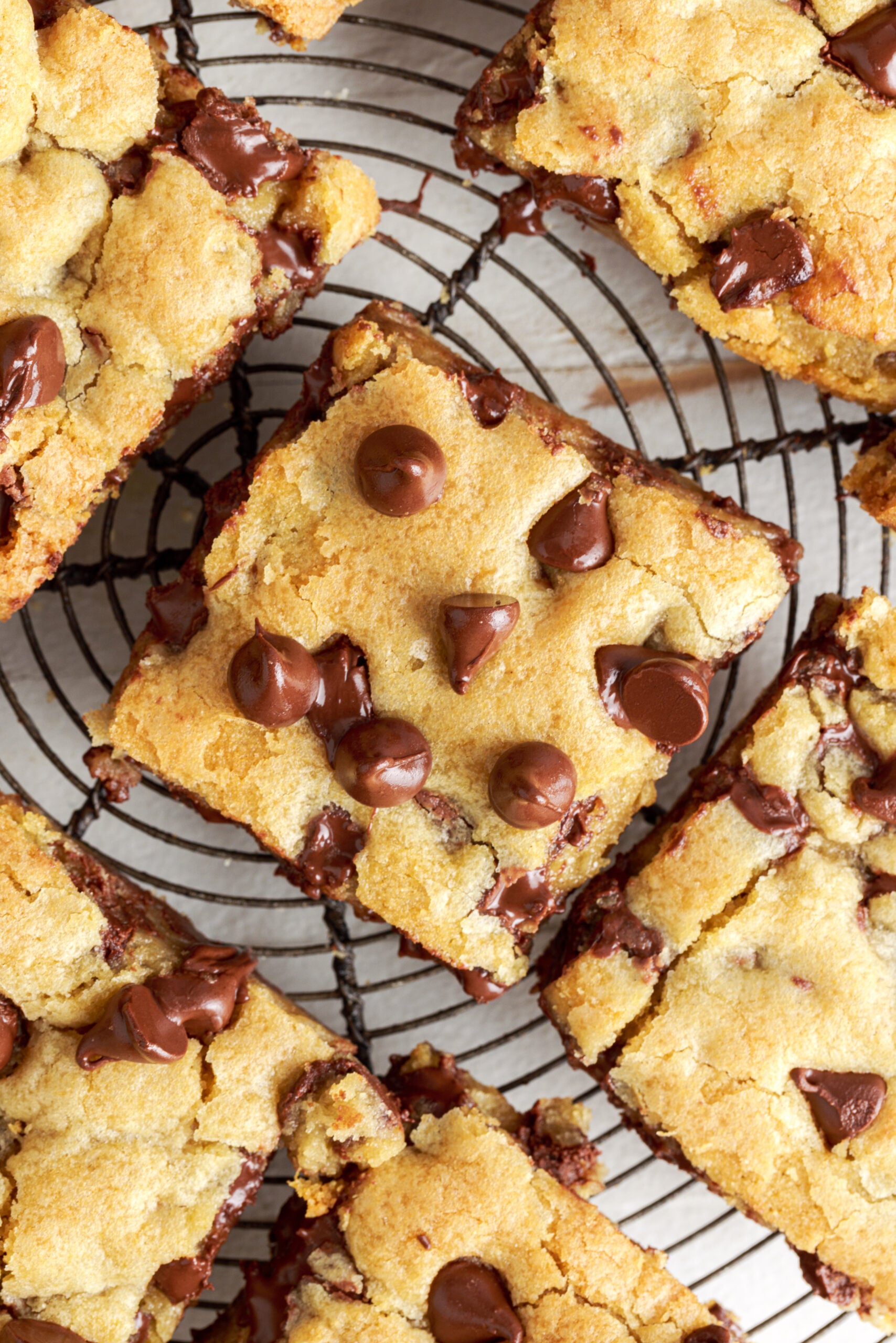 Overhead close up of Gooey Chocolate Chip Cookie Bars on a wire rack.