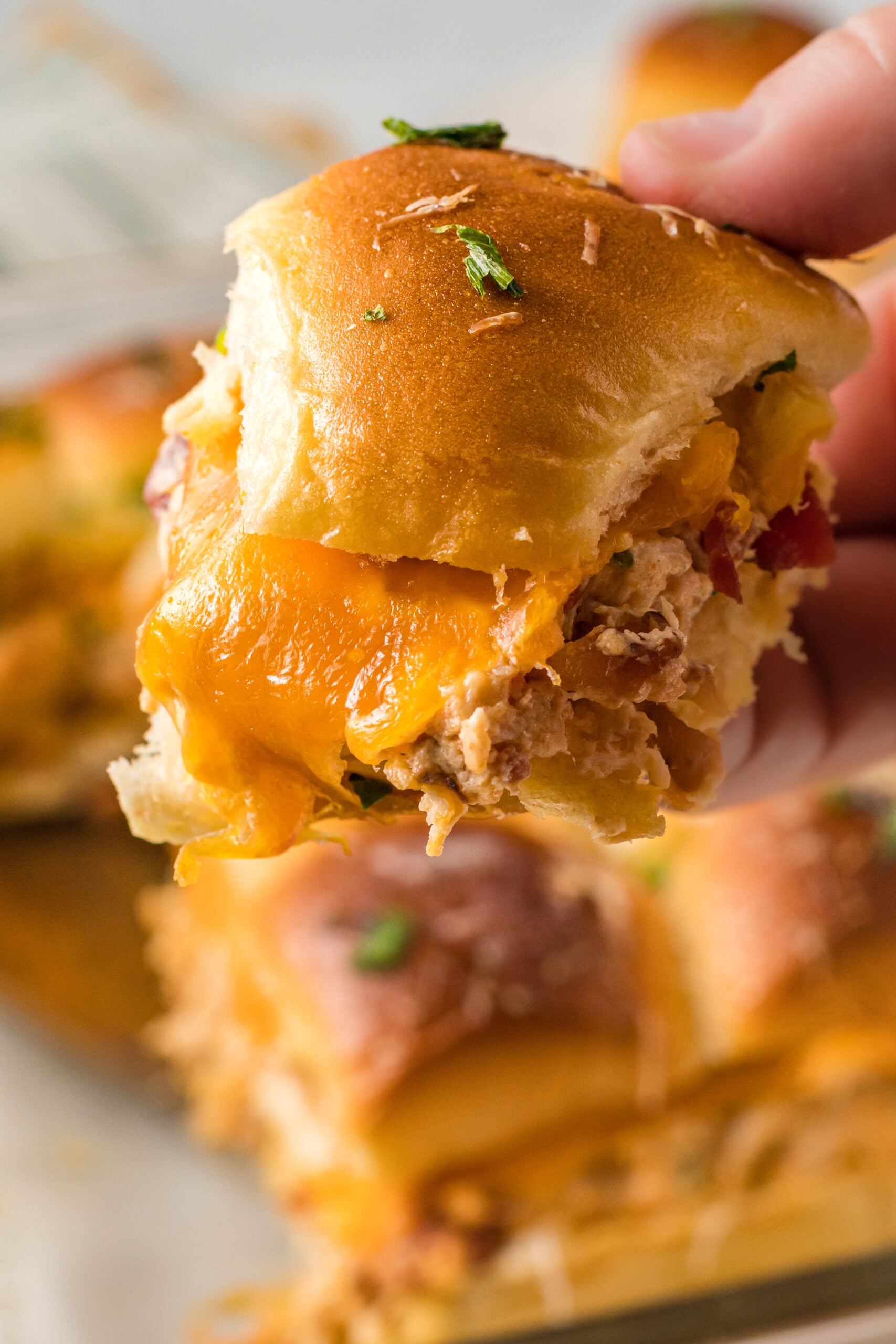 Up close view of Crack Chicken Sliders
being held.
