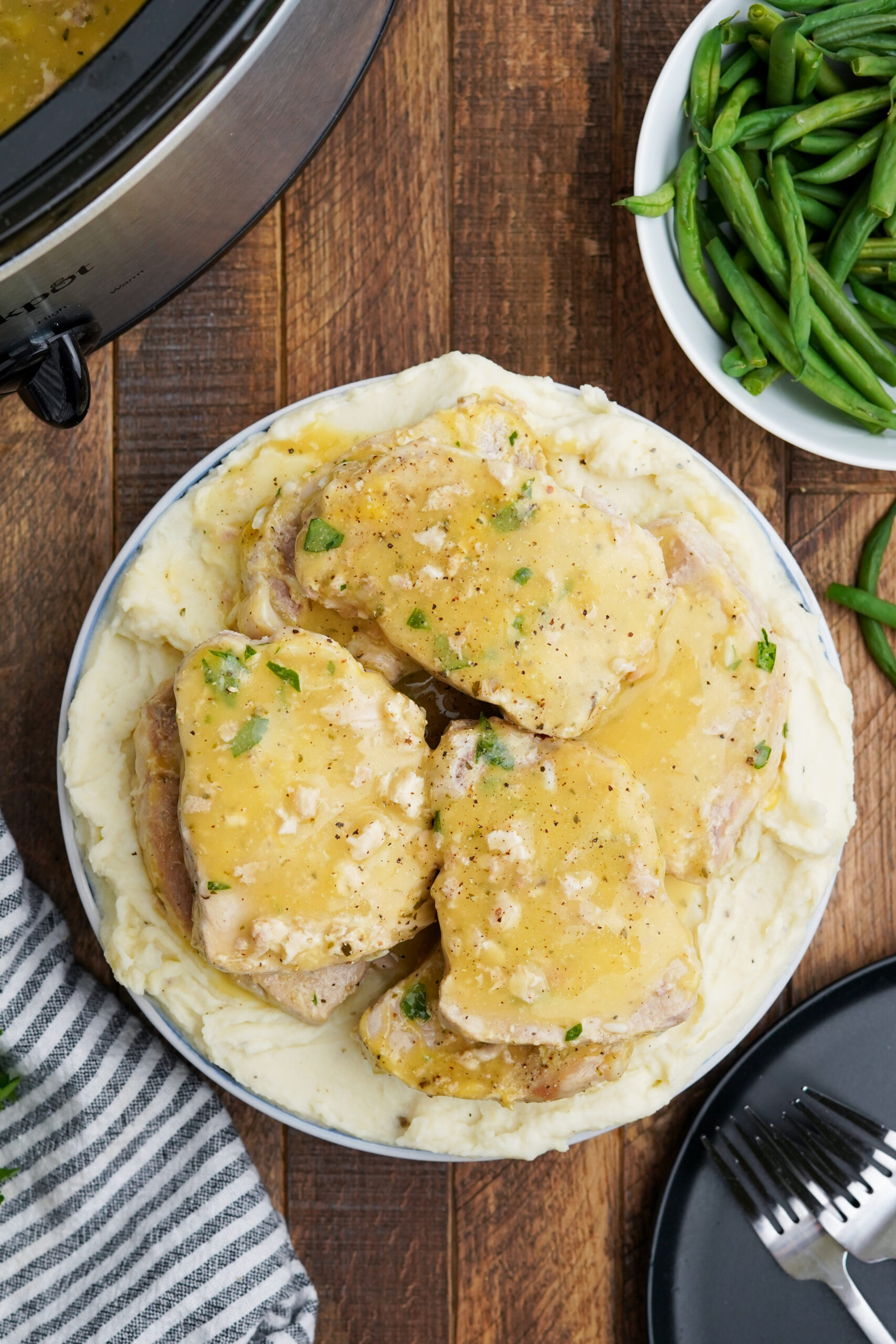 Overhead view of Crock Pot Ranch Pork Chops served over mashed potatoes.