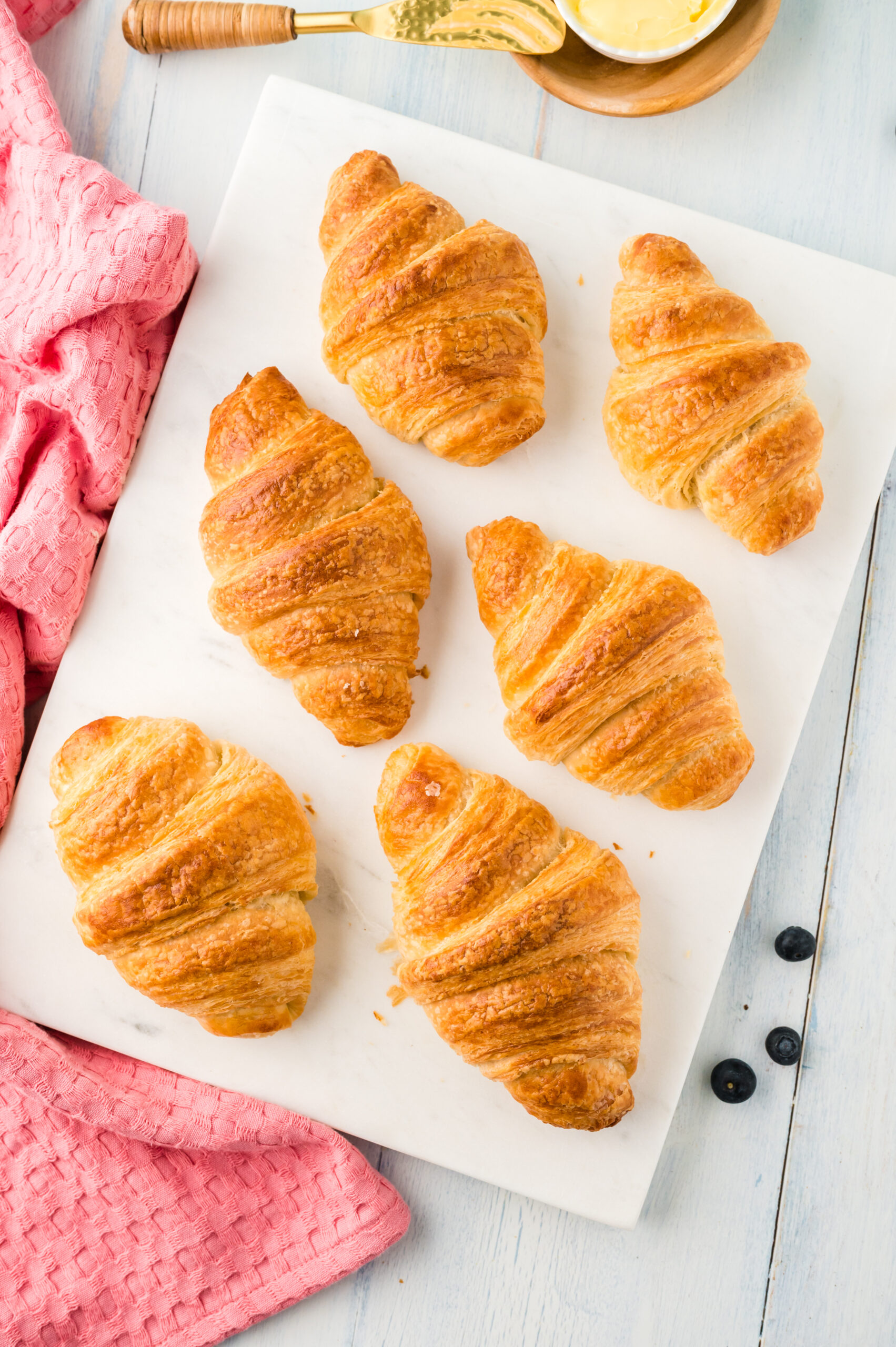 Overhead view of Homemade Croissants on a white serving dish.