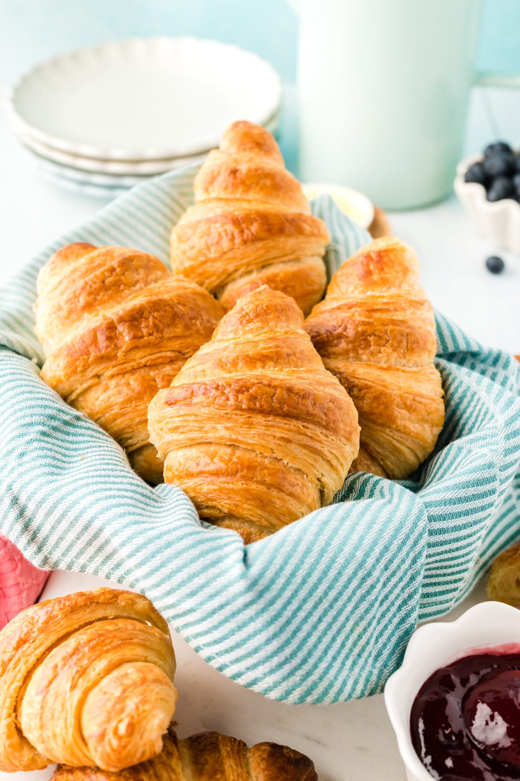 Front view of Homemade Croissants in a dish lined with linen.