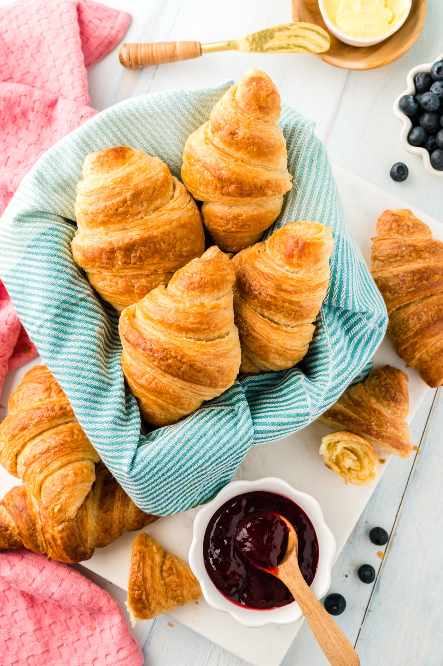 Overhead view of Homemade Croissants in a dish lined with linen.