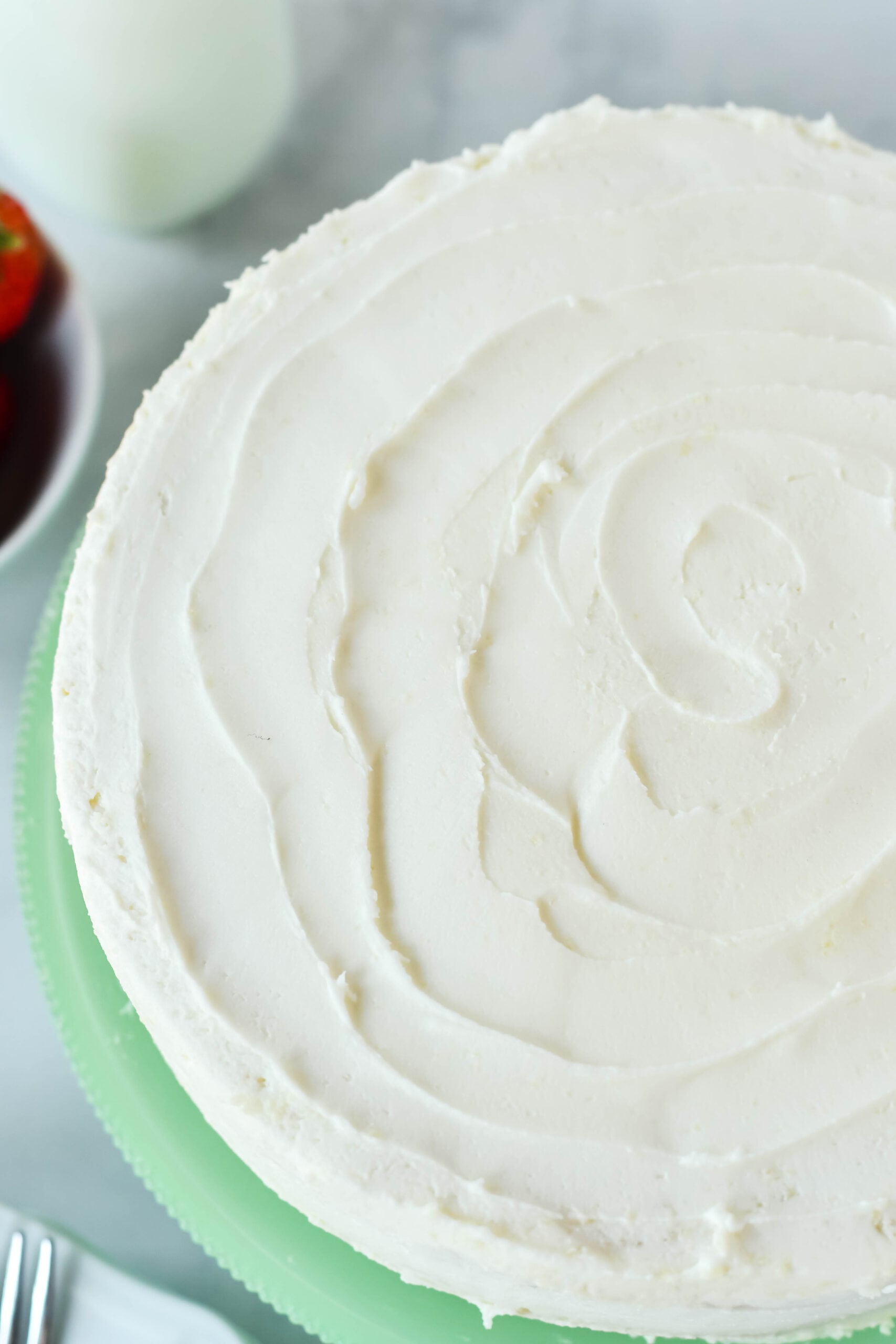 Overhead view of Classic Vanilla Cake on a green cake stand.