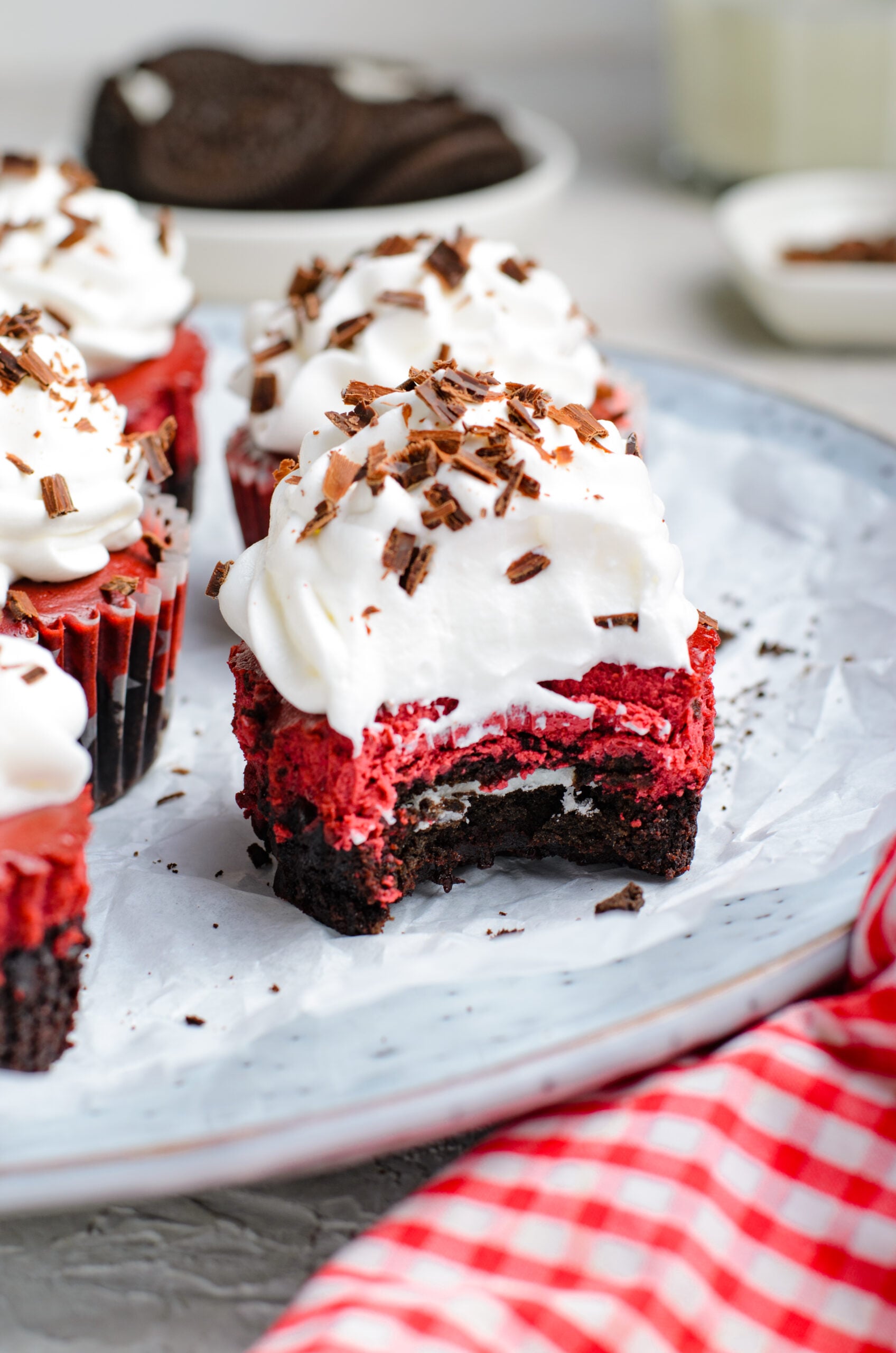 Front view of a Mini Red Velvet Oreo Cheesecake with a bite removed.