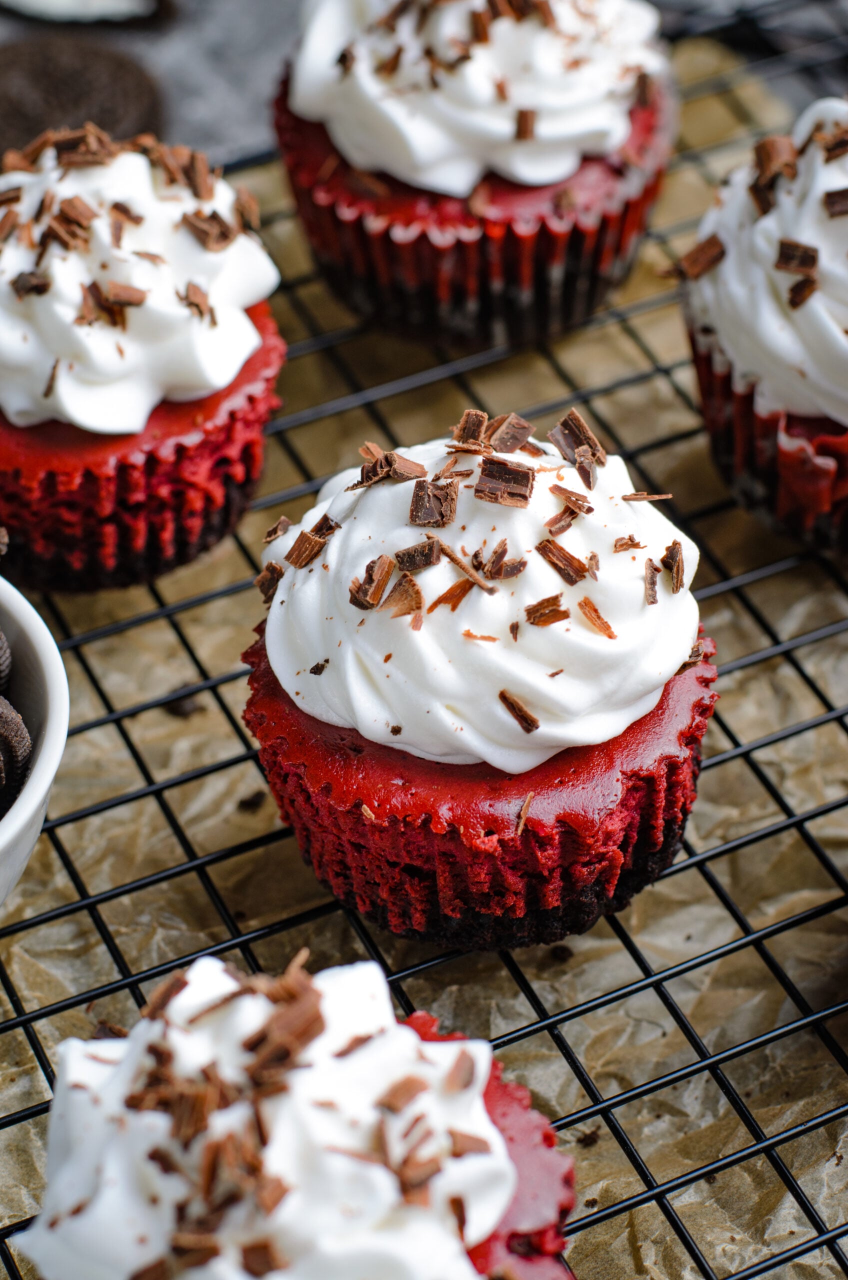 Close up view of Mini Red Velvet Oreo Cheesecakes on a back wire rack.