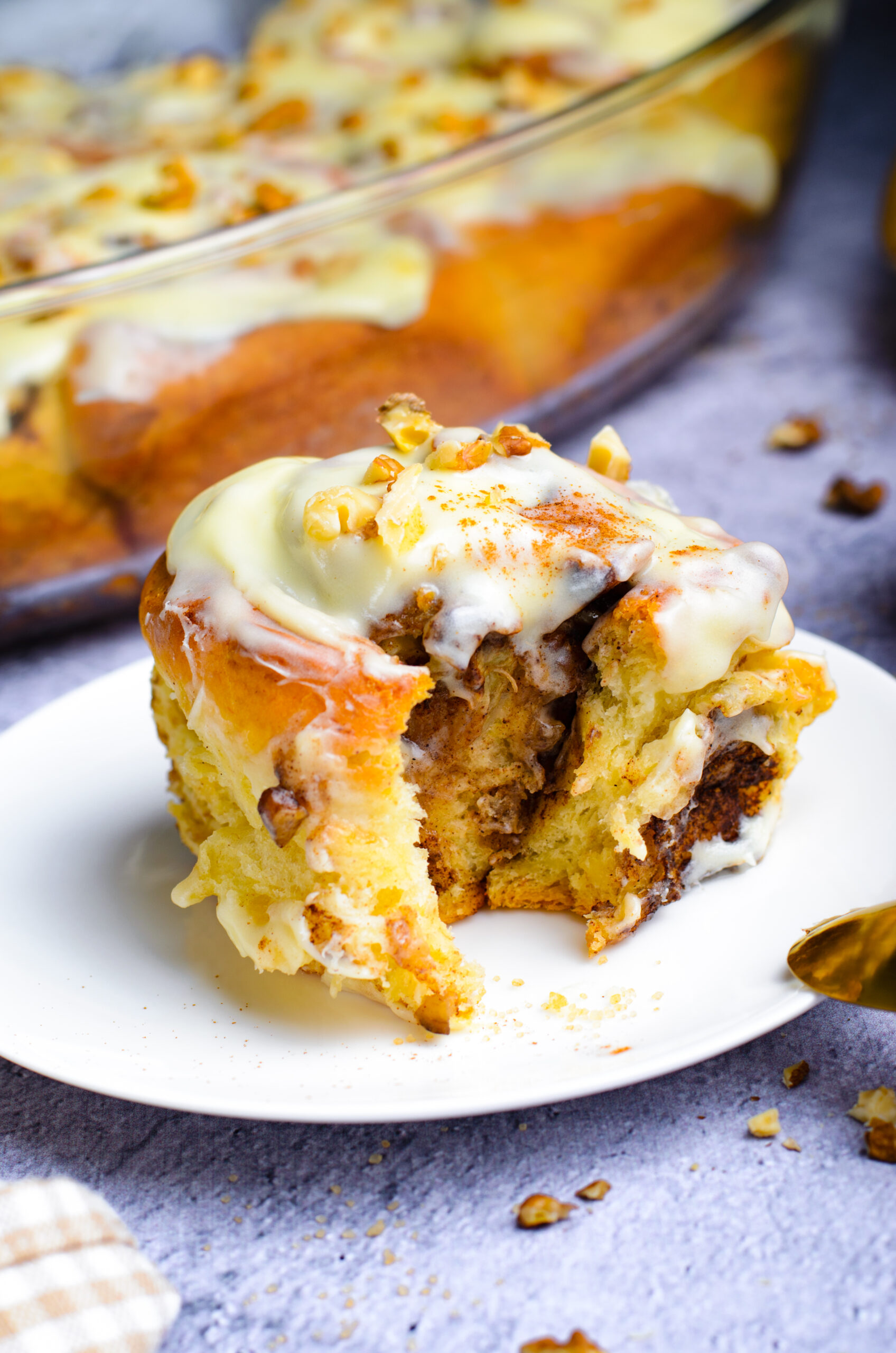 Front view of a Banana Nut Cinnamon Roll with a bite removed.