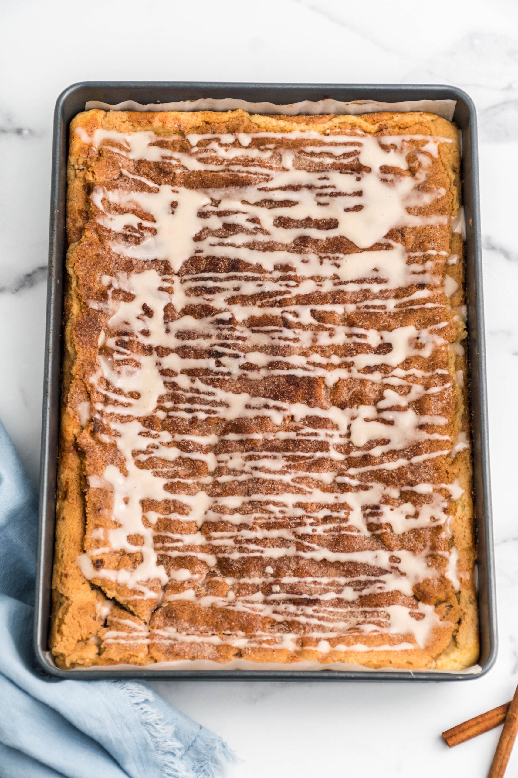 Overhead view of Snickerdoodle Cheesecake Bars in a baking pan.