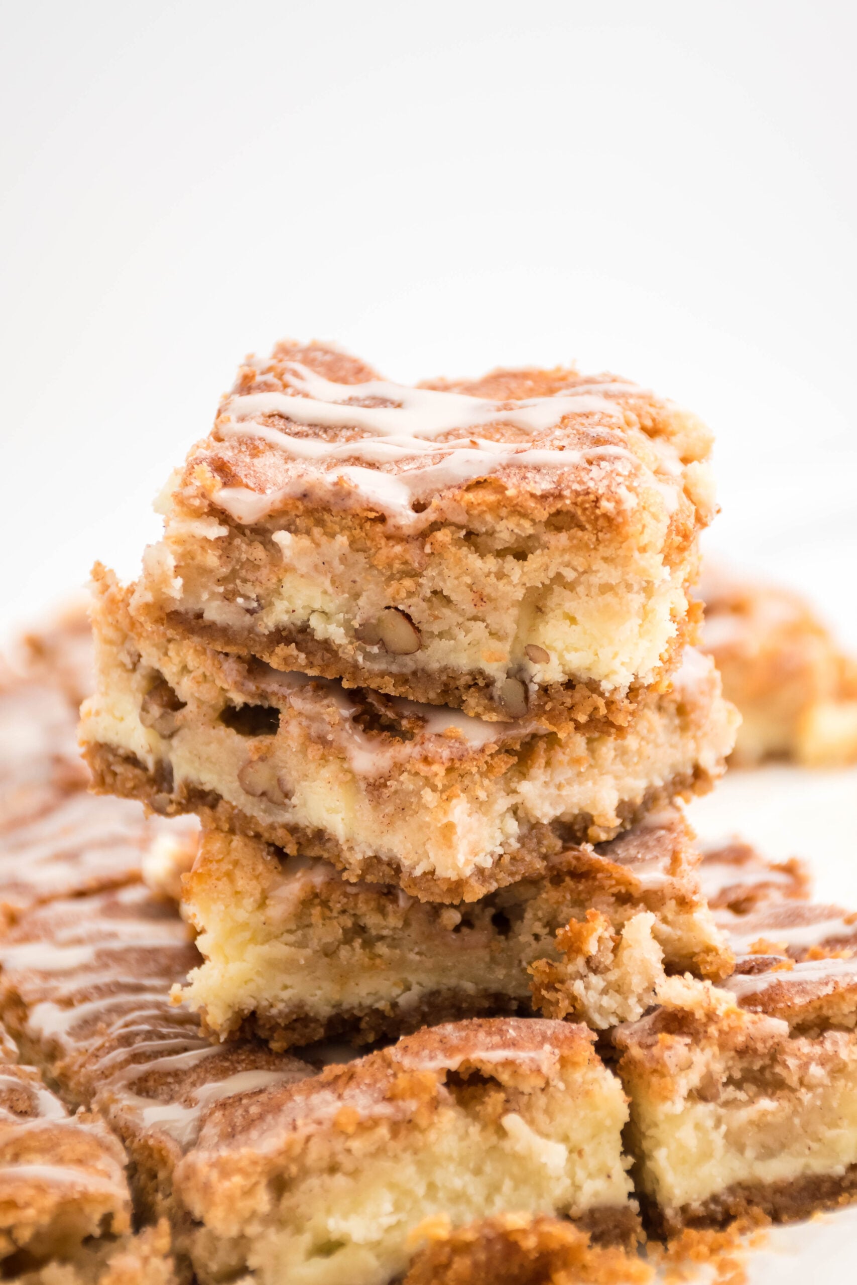 Front view of three Snickerdoodle Cheesecake Bars stacked.