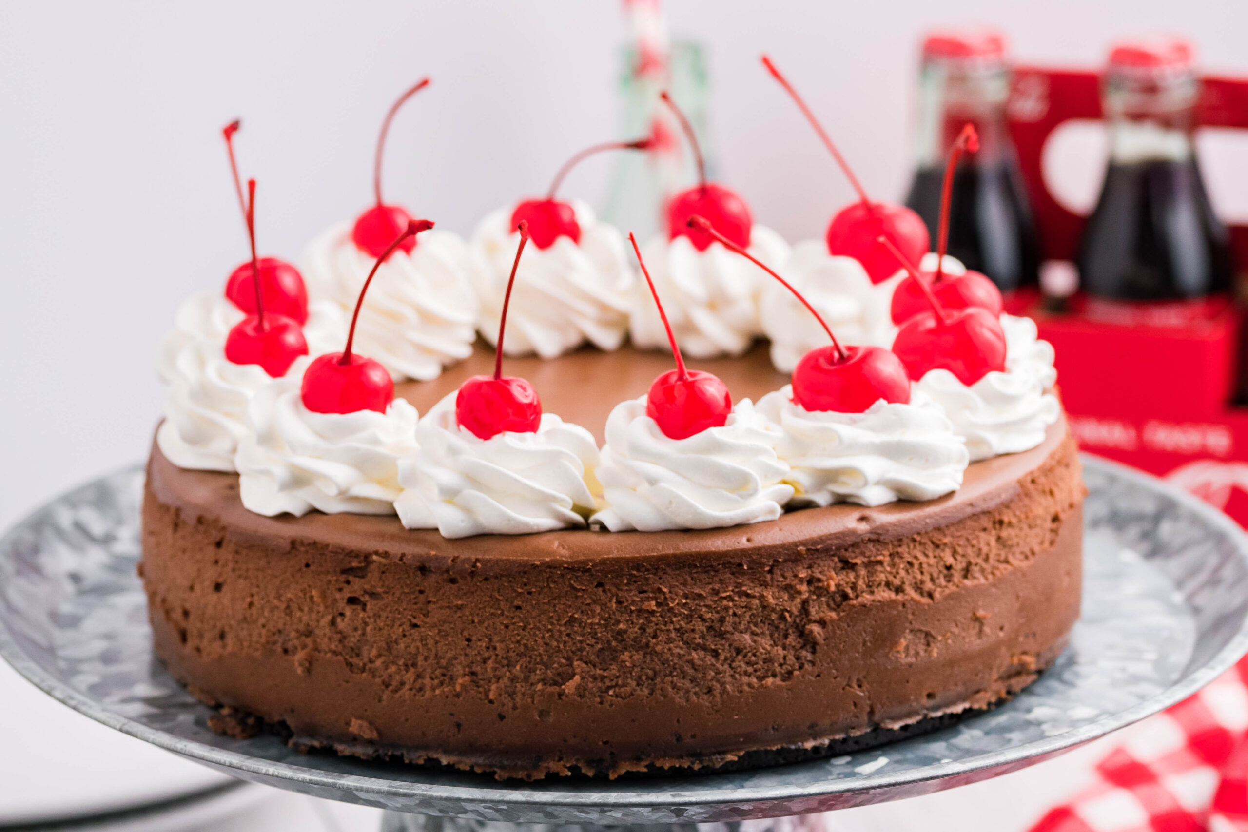 Side view of Coca Cola Cheesecake on a galvanized cake pan.