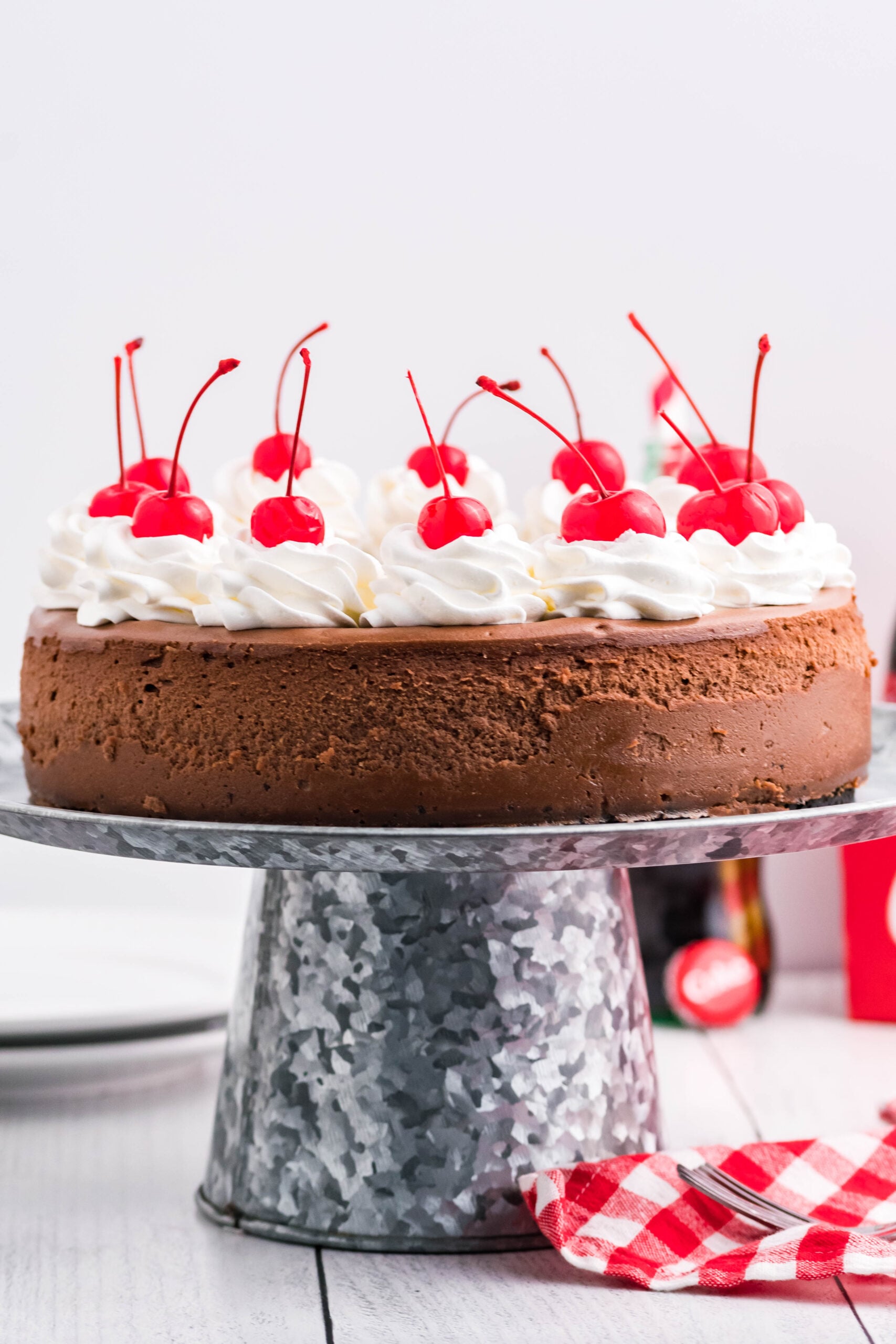 Side view of Coca Cola Cheesecake on a galvanized cake pan.