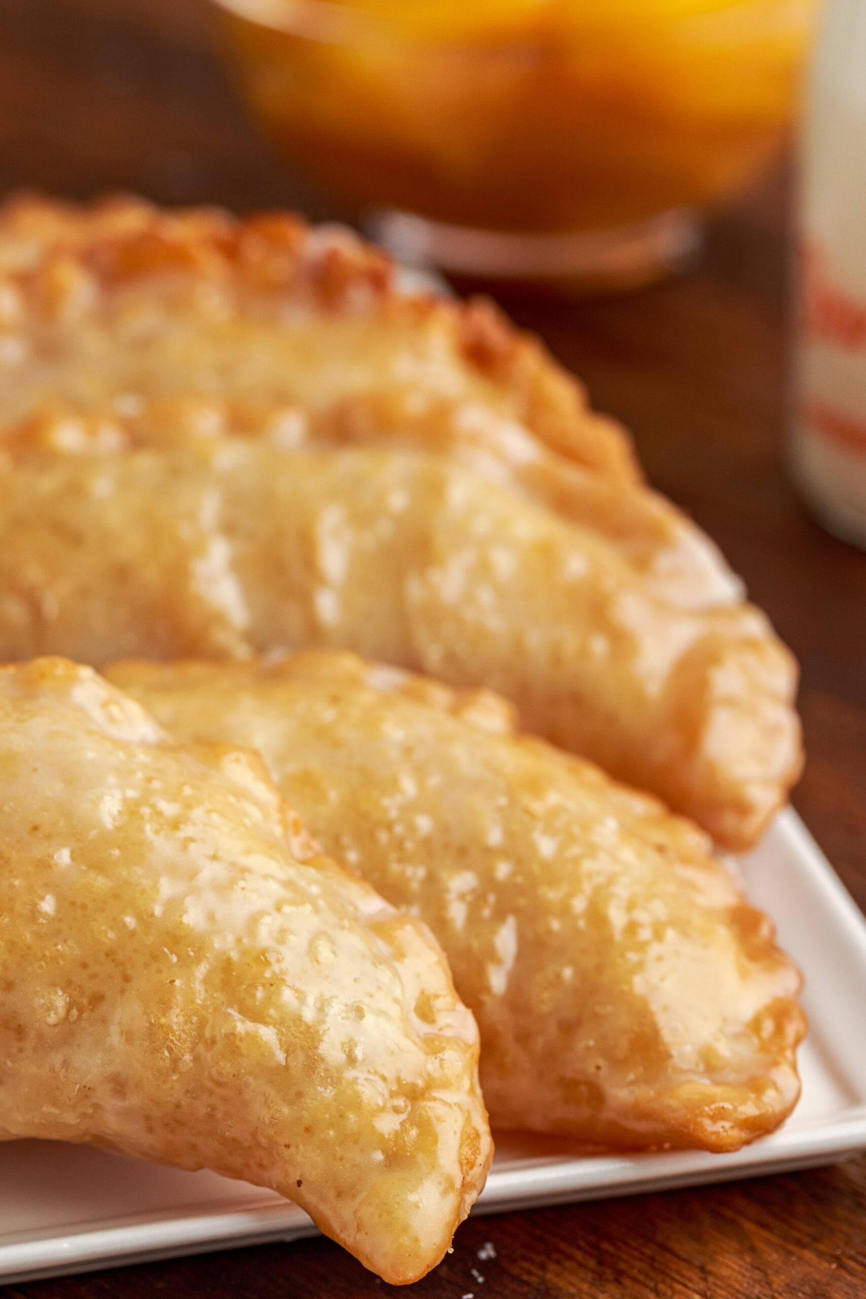 Up close view of Peach Hand Pies on a white serving dish.
