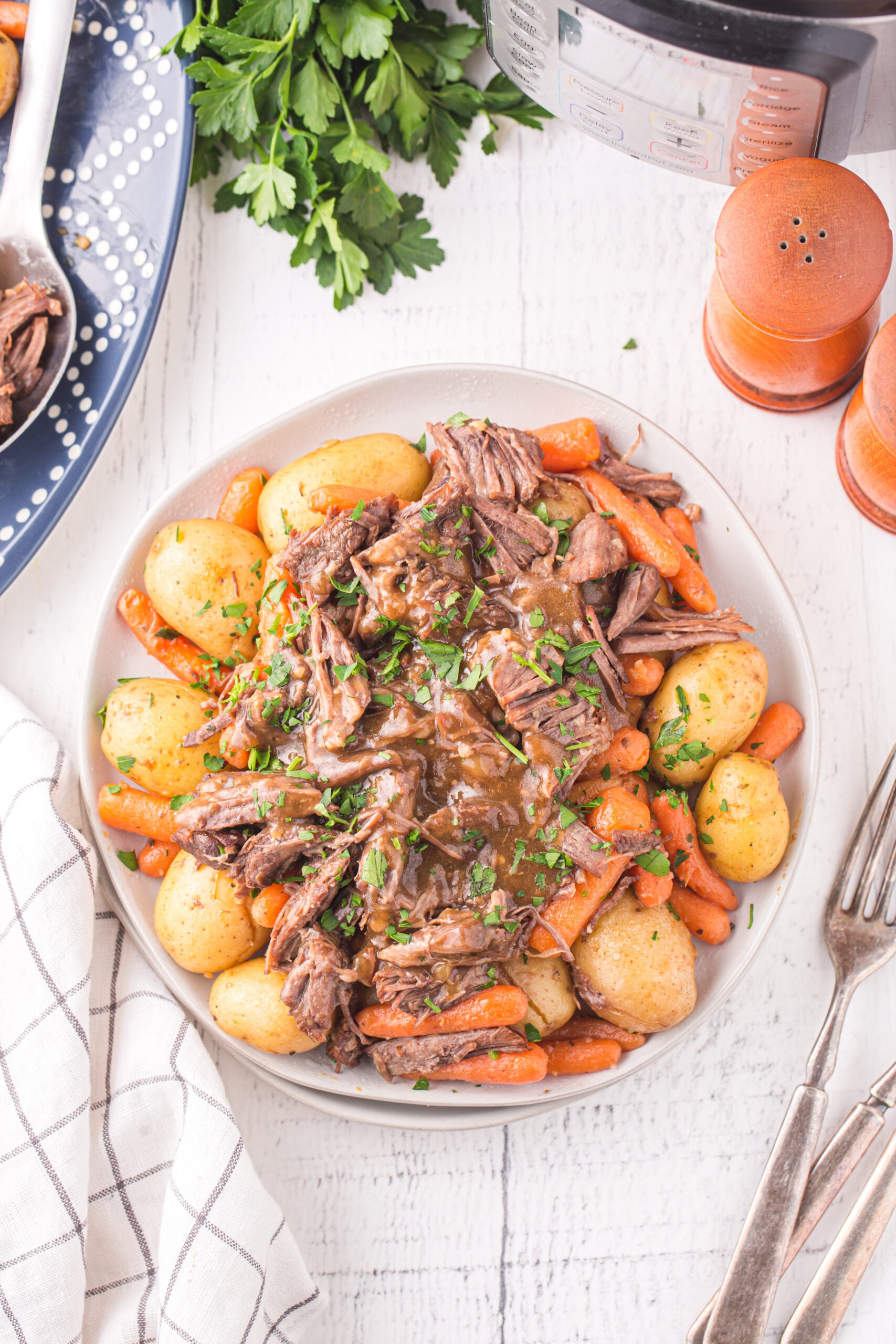 Overhead view of the Pot Roast with potatoes and carrots on a white plate.