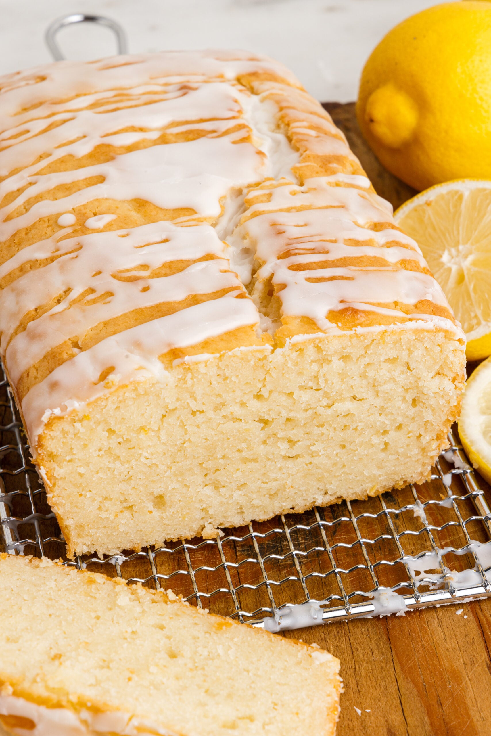 Front view of Lemon Bread on a wire rack with slices removed.