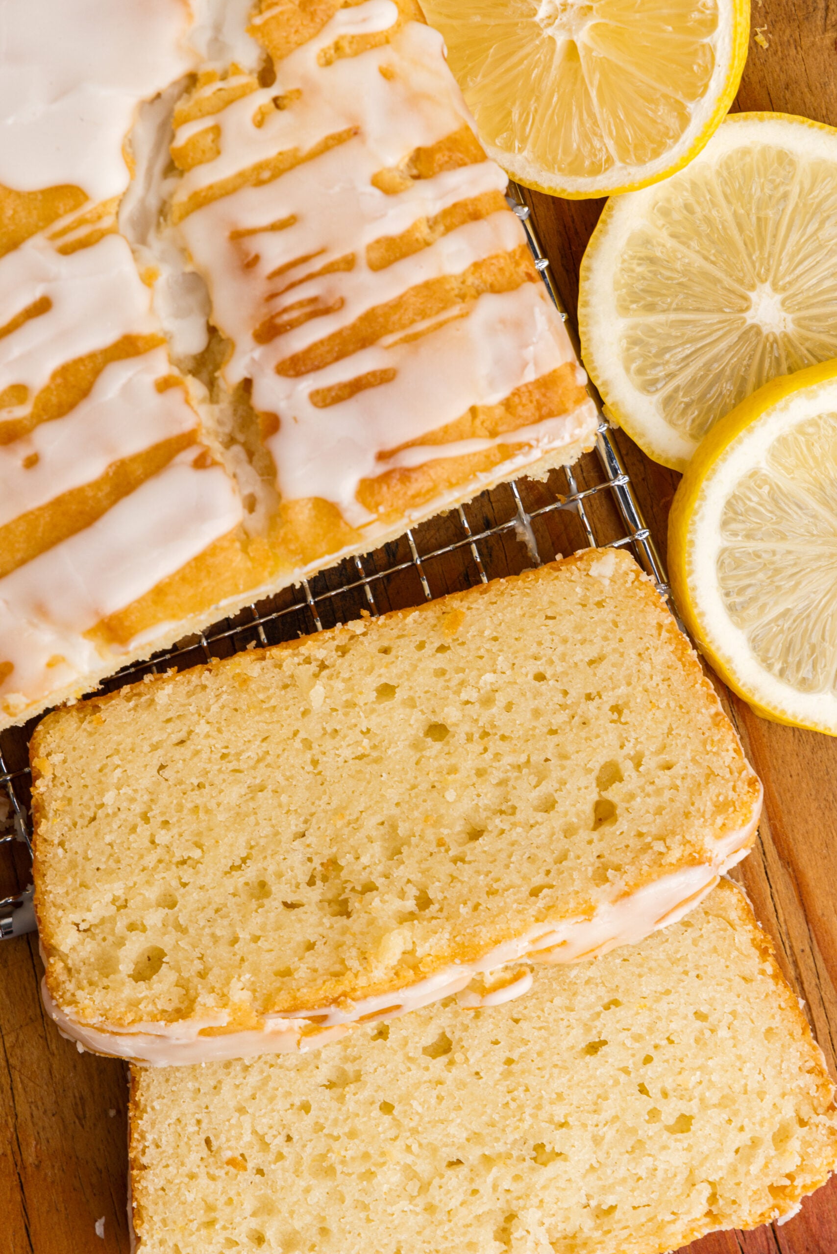 Overhead view of slices cut from a loaf of Lemon Bread on a wire rack.