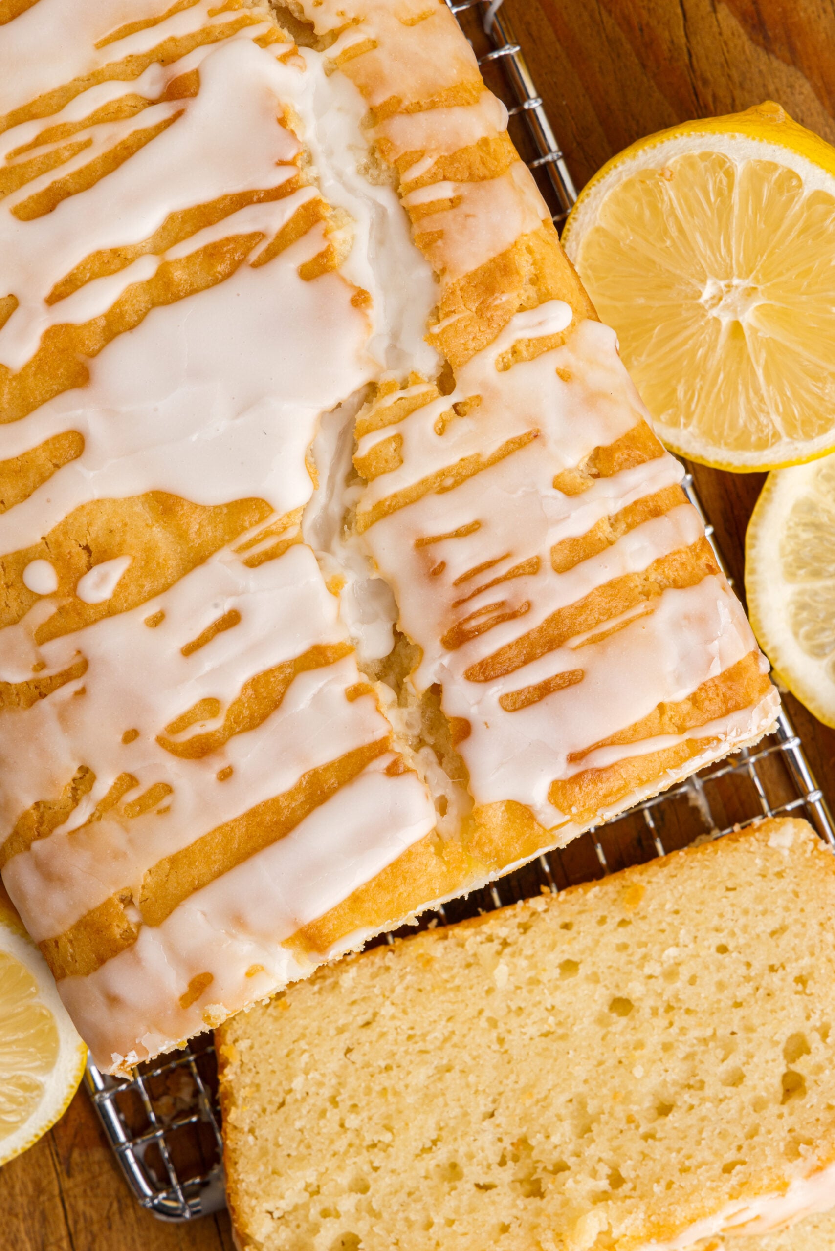 Overhead view of slices cut from a loaf of Lemon Bread on a wire rack.