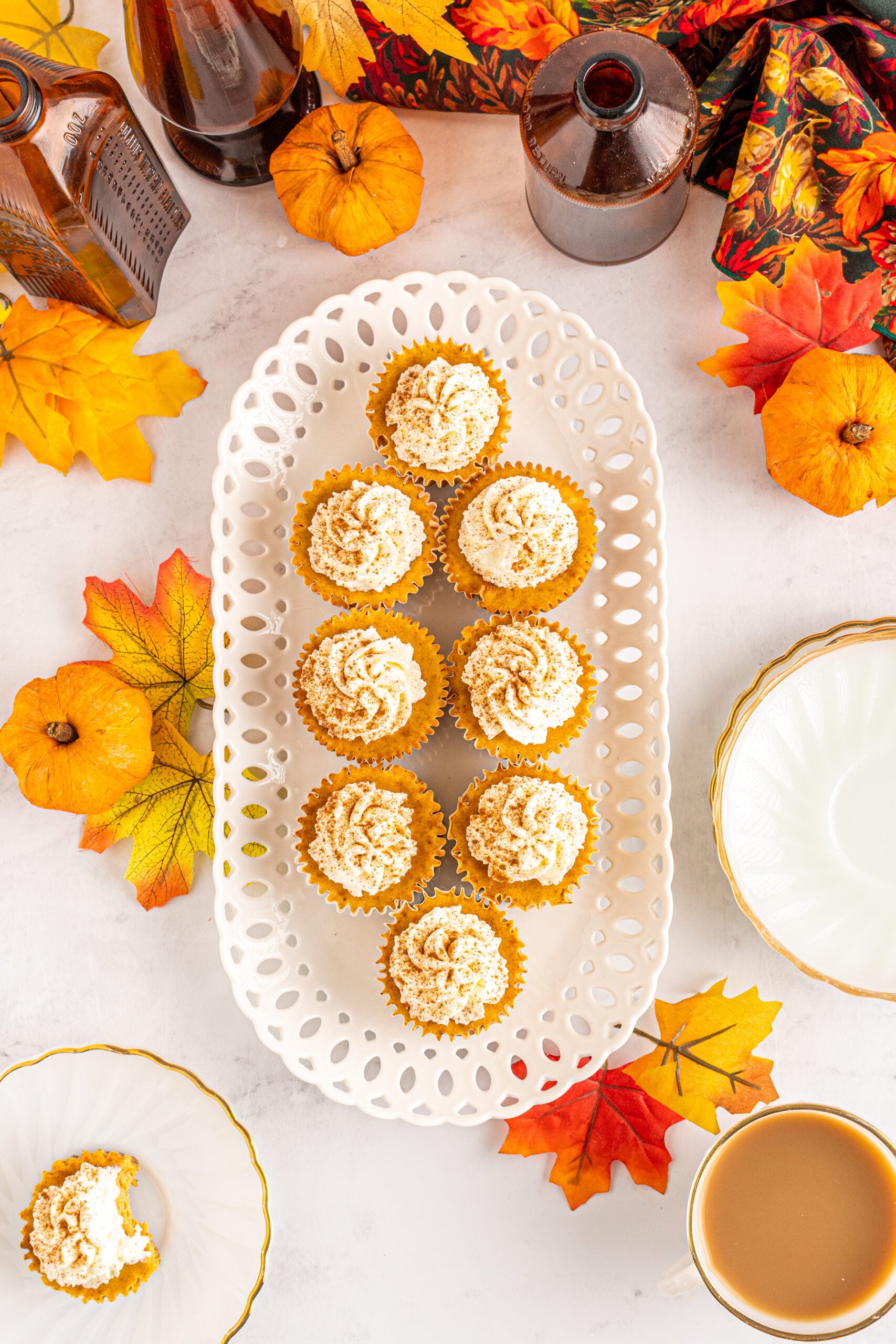 Overhead view of Mini Pumpkin Cheesecakes on a white serving dish.