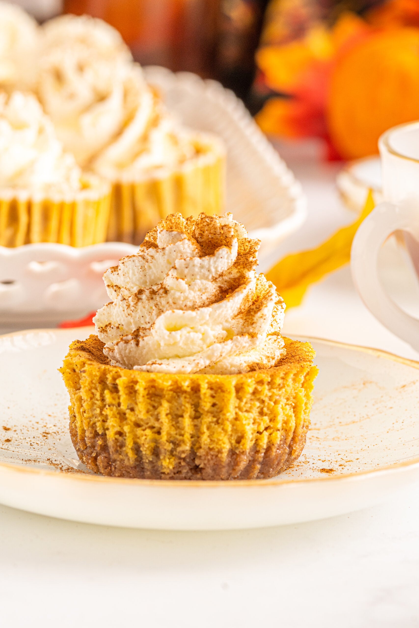 Front view of a Mini Pumpkin Cheesecake on a white dish.