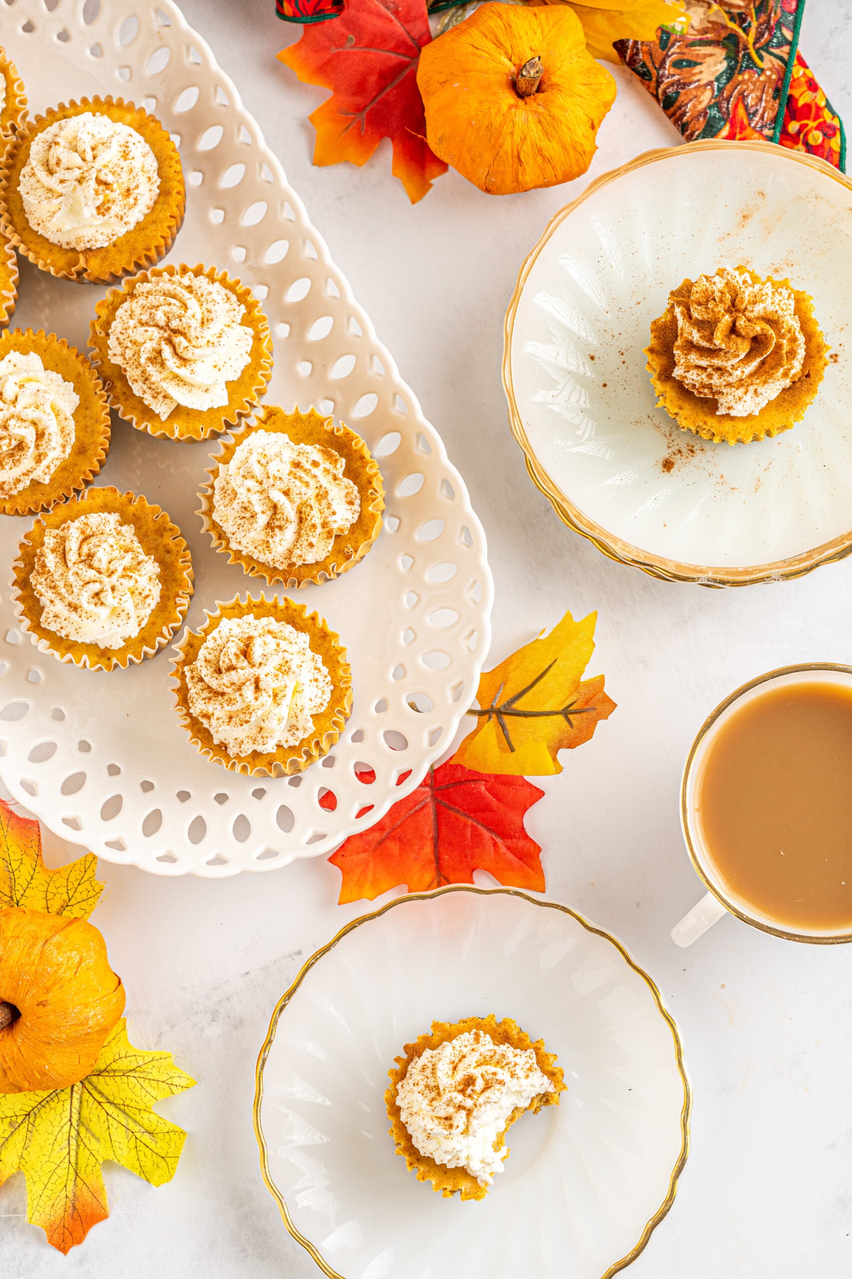 Overhead view of Mini Pumpkin Cheesecakes on a white dishes.
