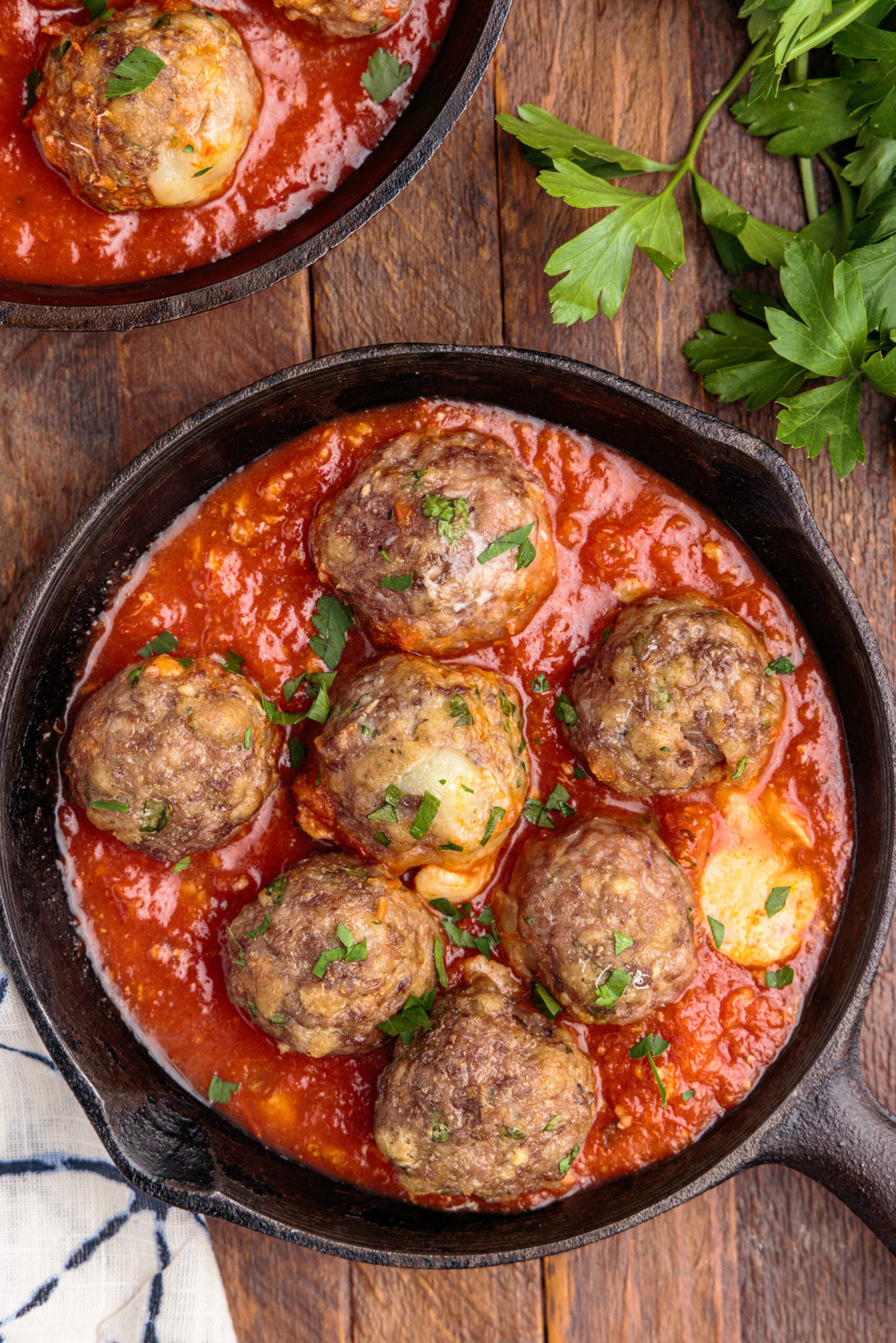 Overhead view of Mozzarella Stuffed Meatballs in a cast iron skillet.