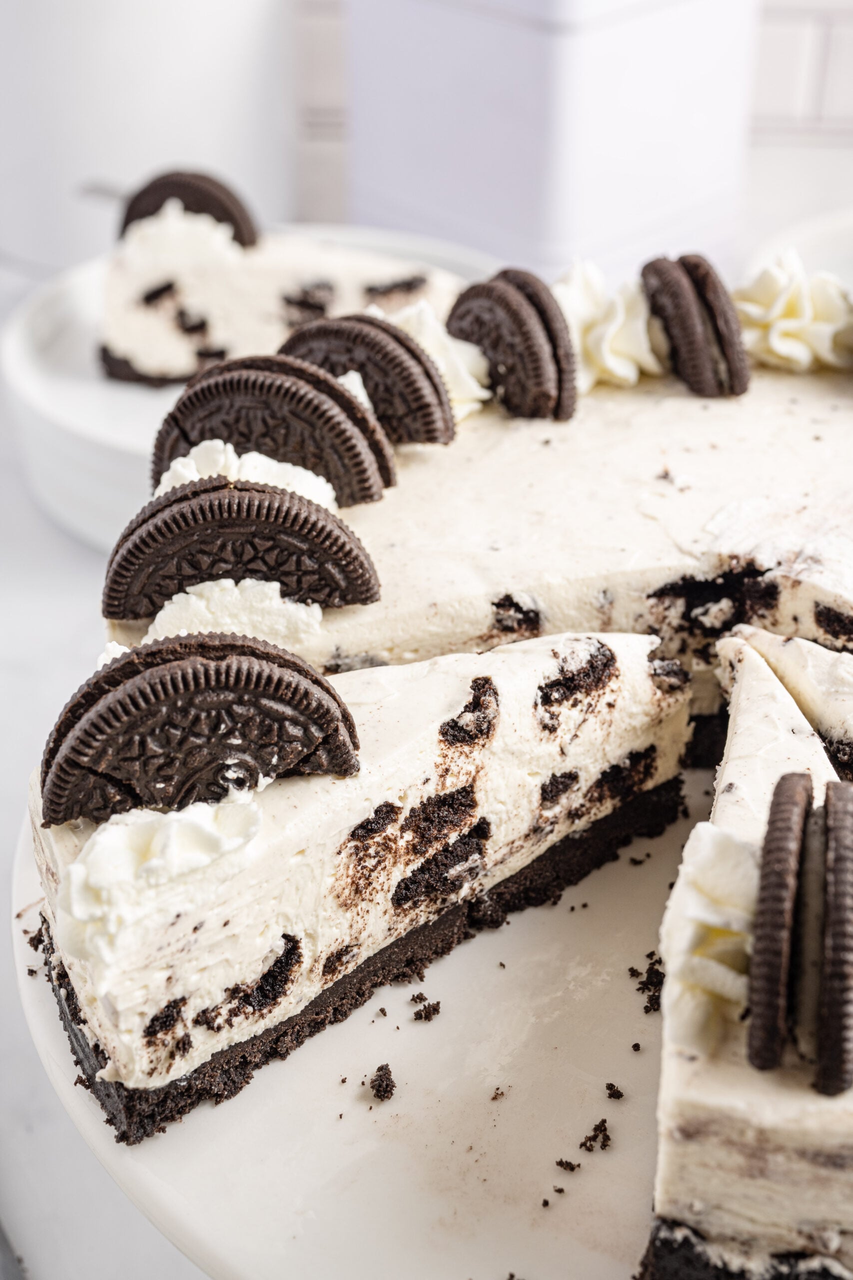 Close up view of No Bake Oreo Cheesecake with 3 slices cut and one removed.