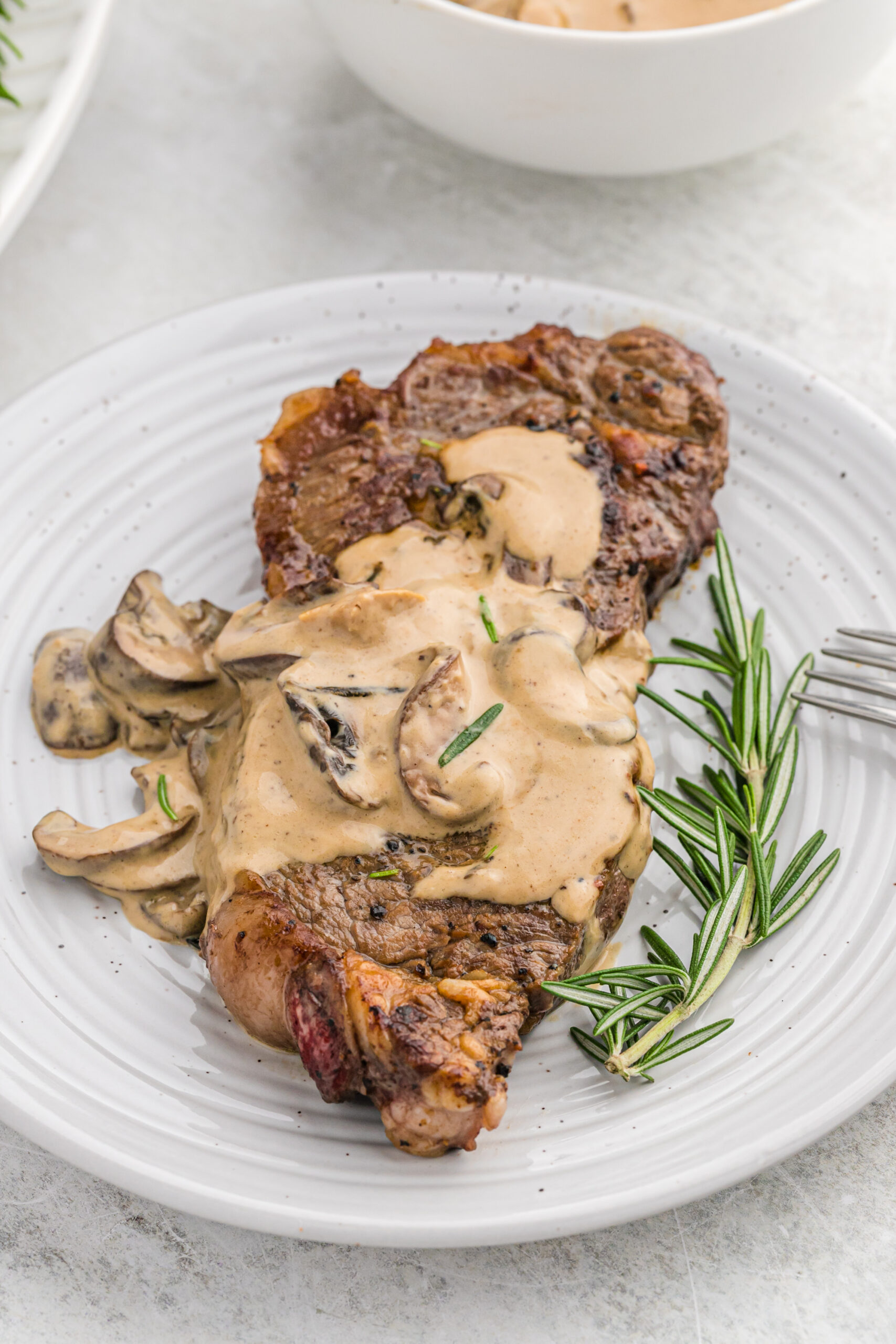 Front view of Garlic Butter Steak on a white dish.