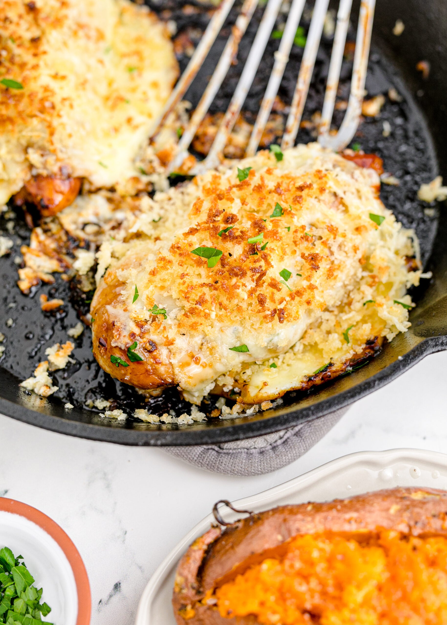 Parmesan Crusted Chicken (Longhorn Copycat) in a cast iron skillet.
