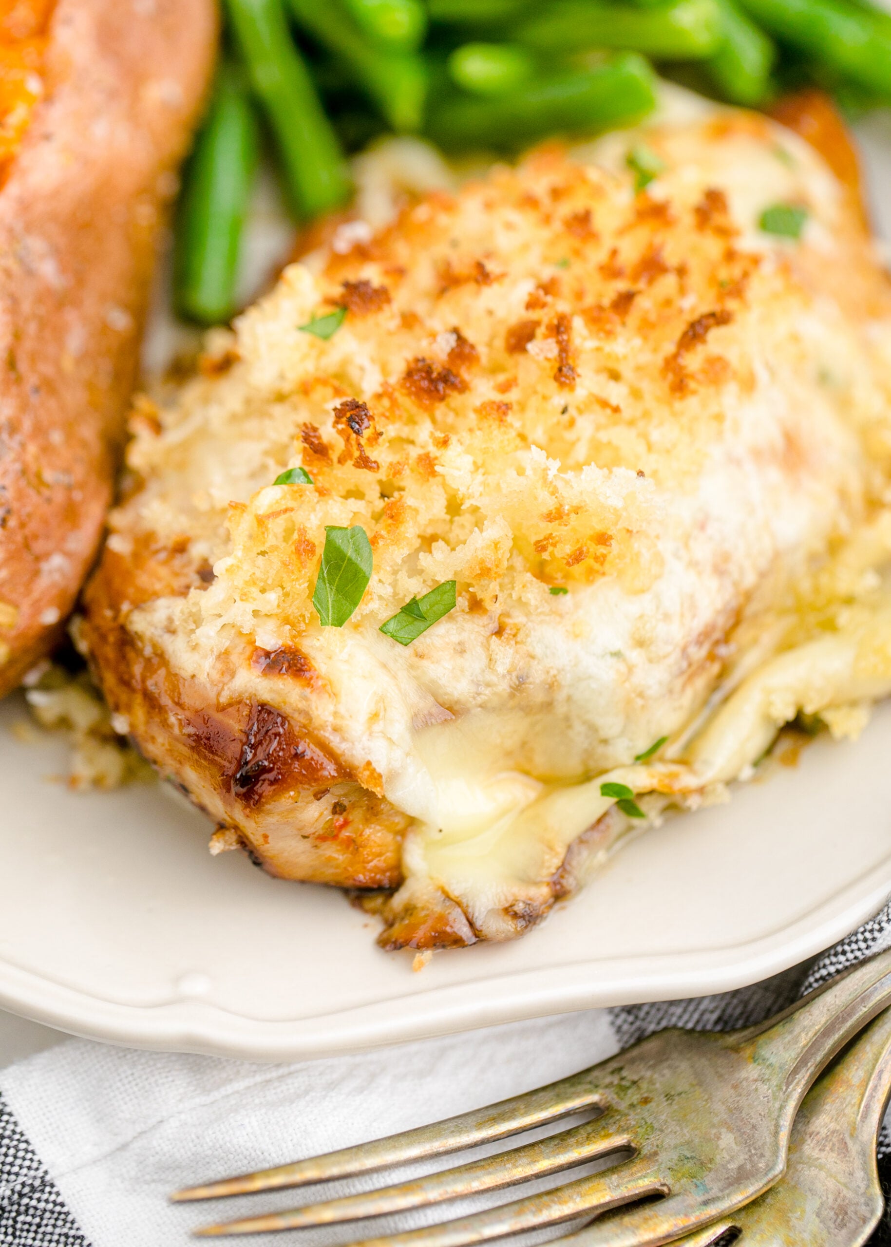 Up close view of Parmesan Crusted Chicken (Longhorn Copycat) on a white dish.