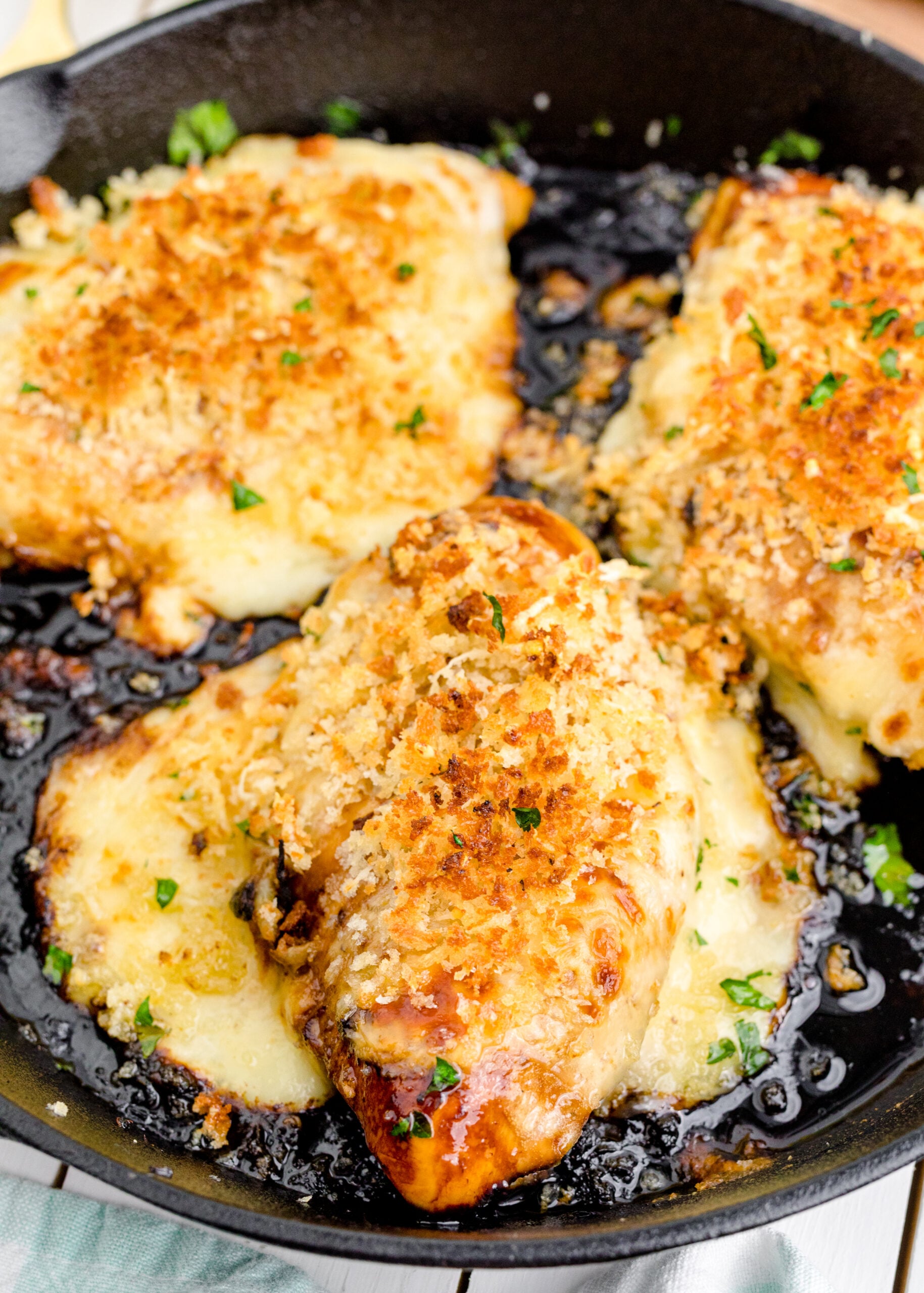 Parmesan Crusted Chicken (Longhorn Copycat) in a cast iron skillet.