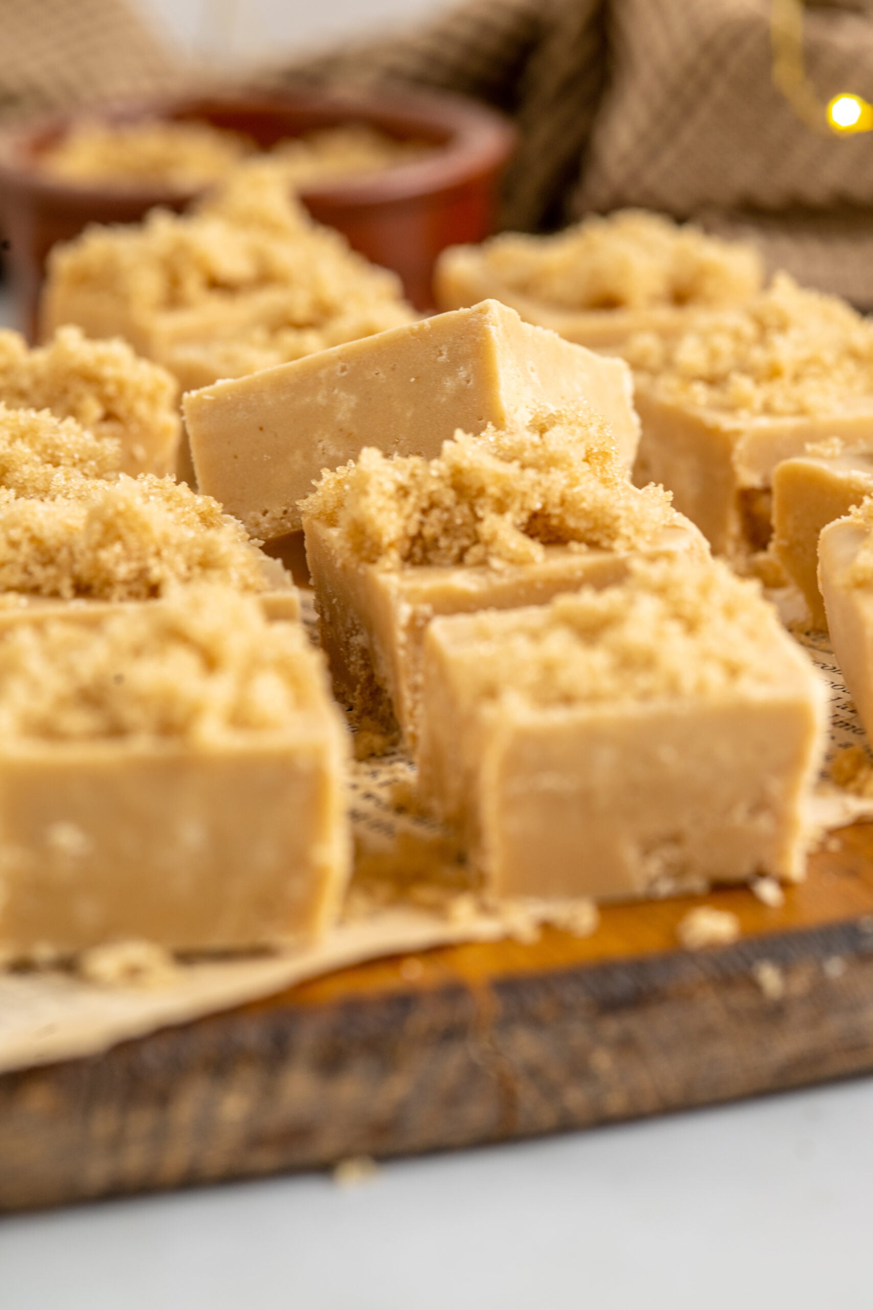 Side view of Penuche Fudge on a wooden board.