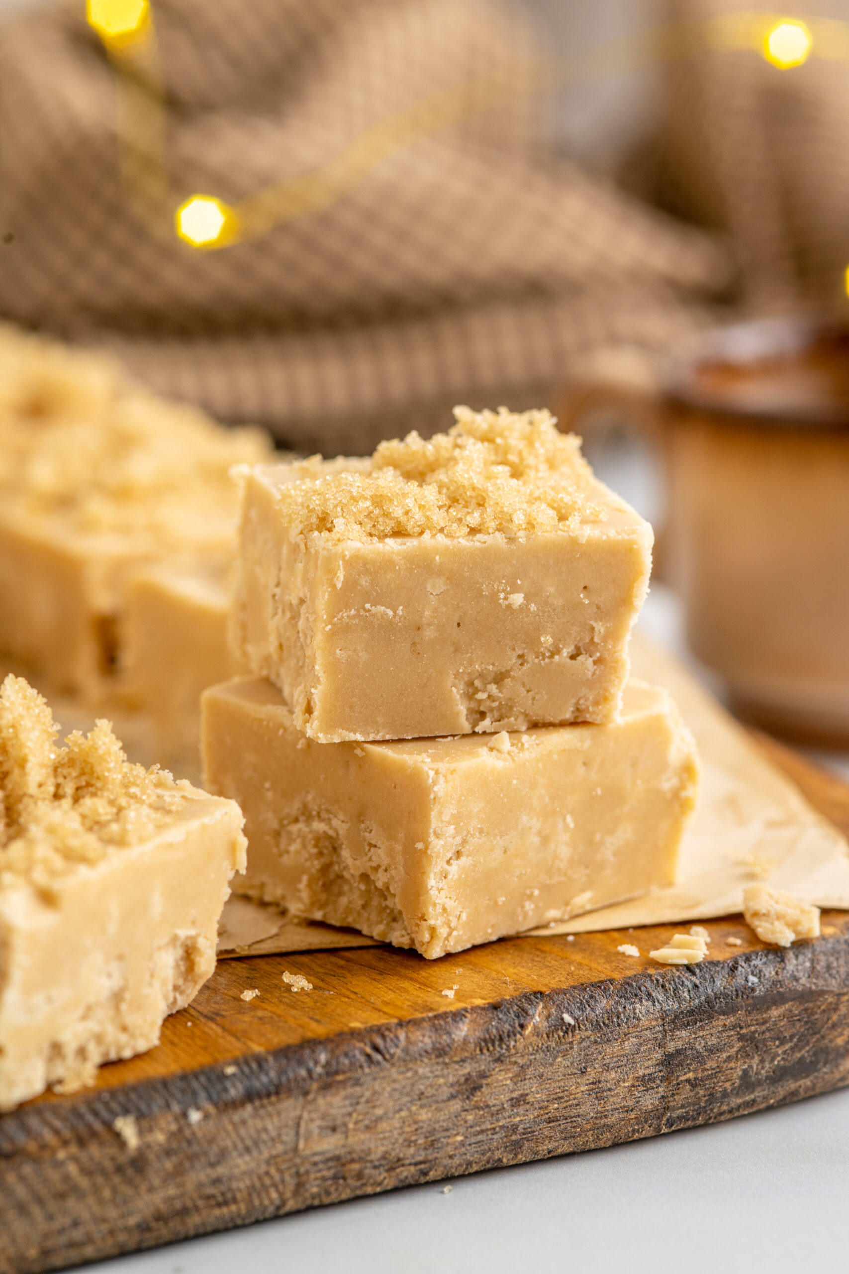 2 pieces of Penuche Fudge on a wooden board.