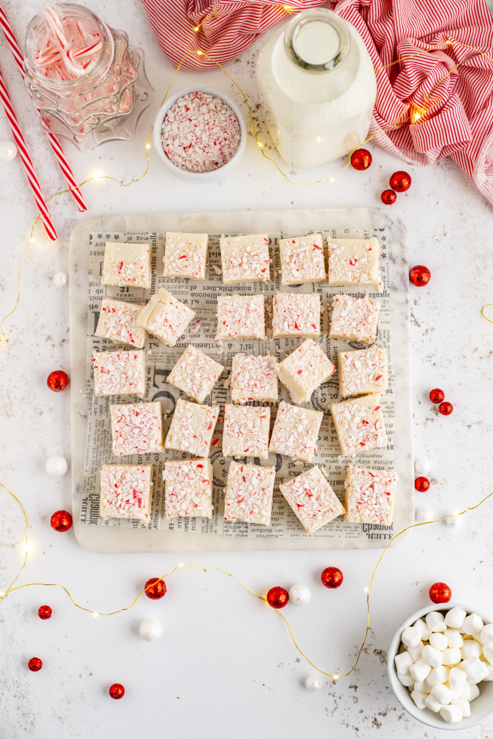 Peppermint fudge cut up into small squares topped with crushed peppermint.
