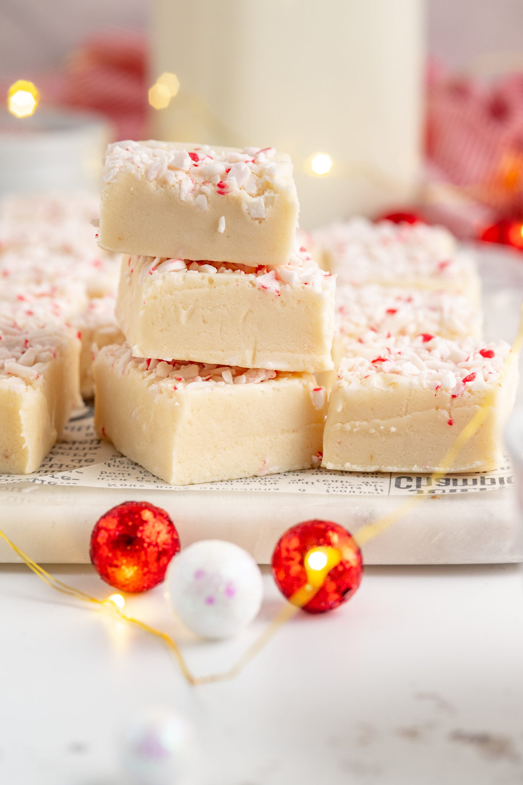 Three pieces of peppermint fudge stacked on top of each other.